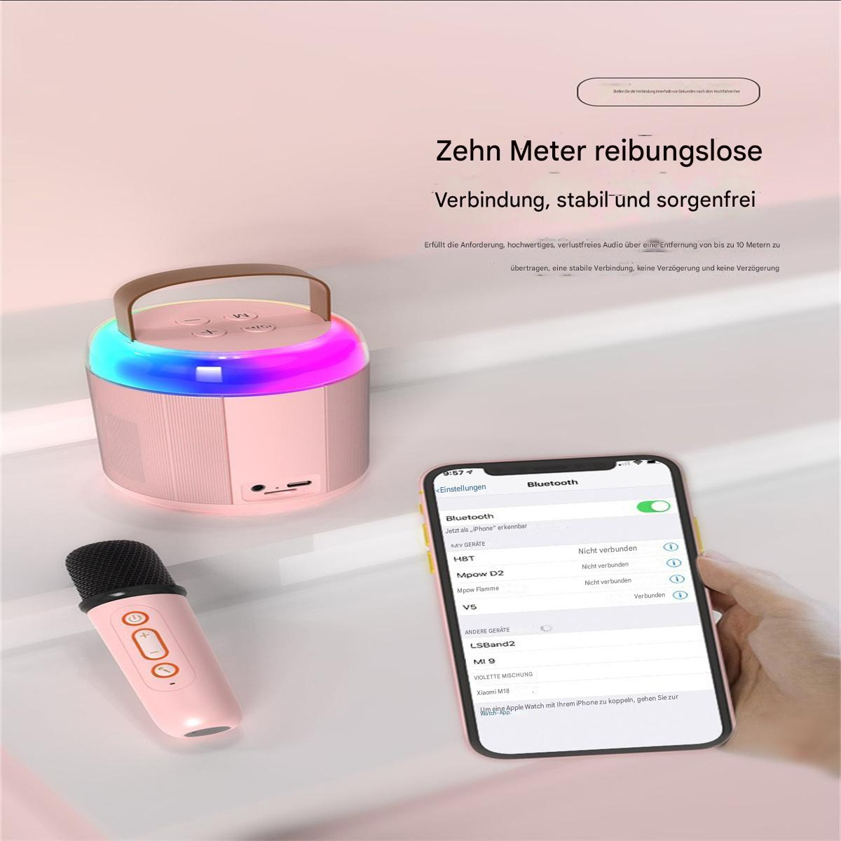 Rosa Lautsprecher, Mikrofon und Smartphone auf rosa und weißem Grund.