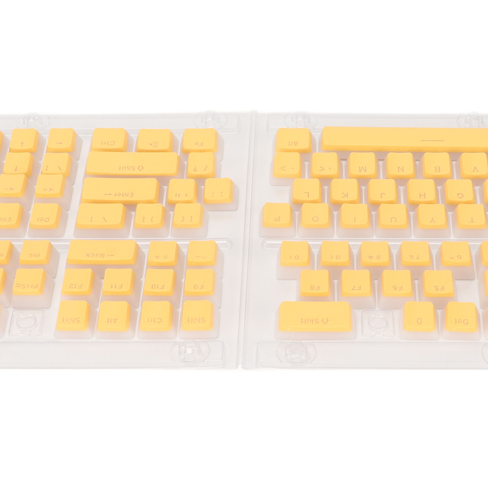 Gelbe Tastaturtasten in durchsichtiger Plastikverpackung. Tasten sind in Reihen angeordnet.
