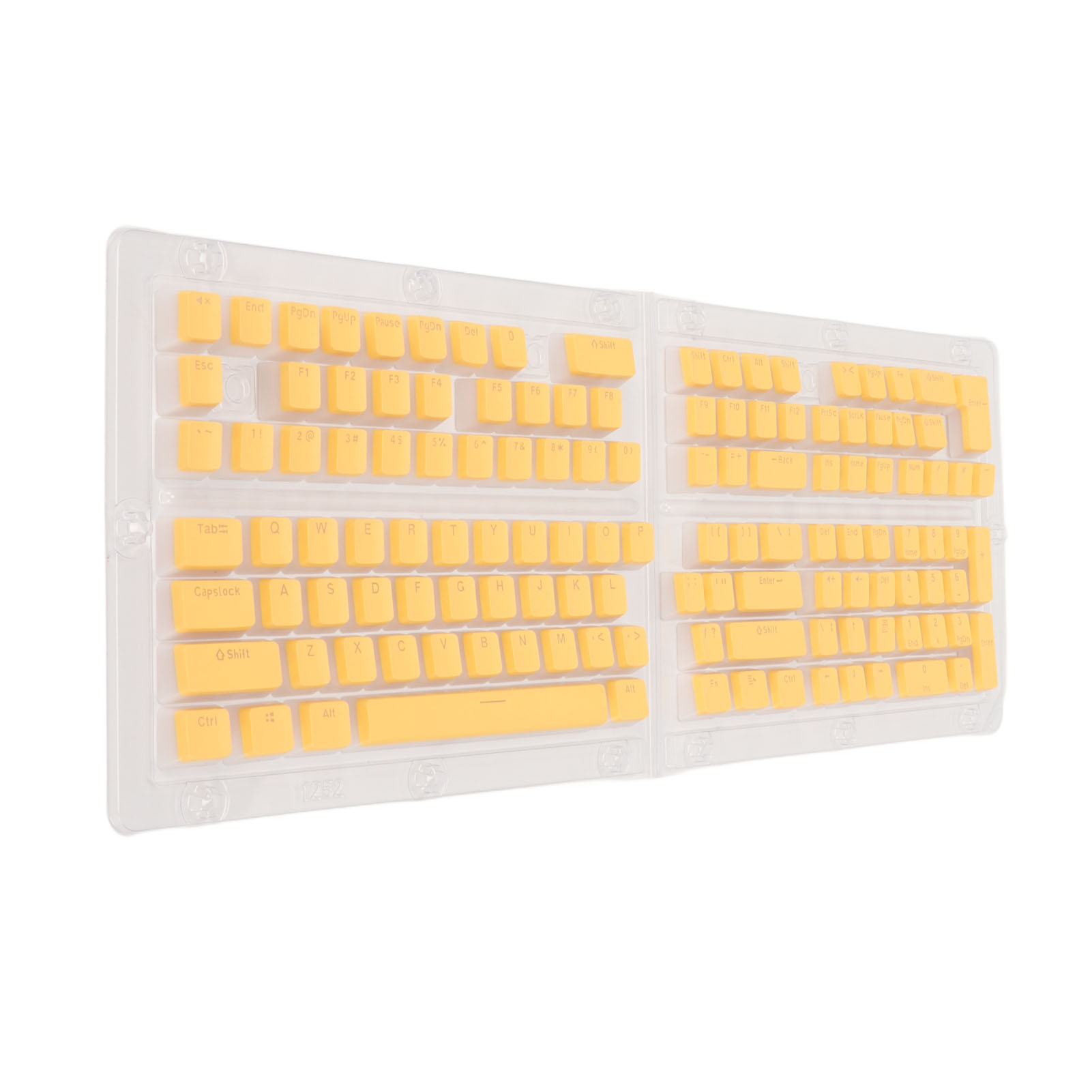 Tastaturtasten. Die Tasten sind gelb, und die Tastaturbasis ist transparent. Die Tasten sind in einer Schale.