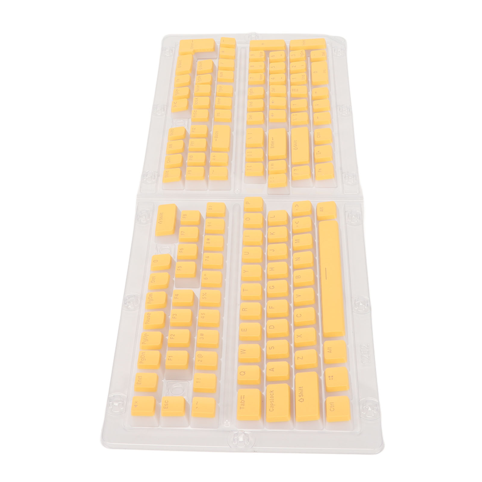 Gelbe Tastenkappen sind in einer transparenten Plastikschale angeordnet. Sie zeigen Buchstaben, Zahlen und Symbole für eine Tastatur.