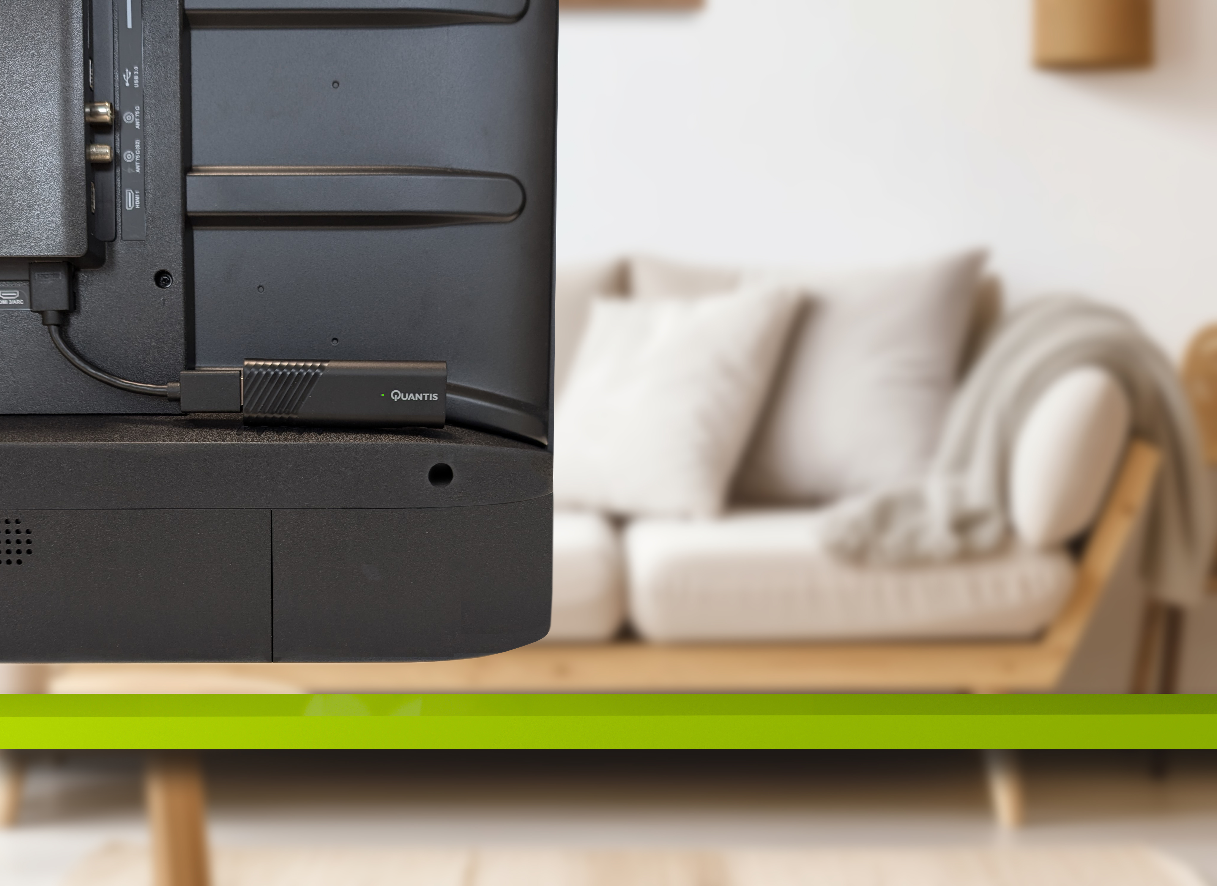 Back of a black TV with a Quantis dongle plugged in.  A couch is in the blurred background.