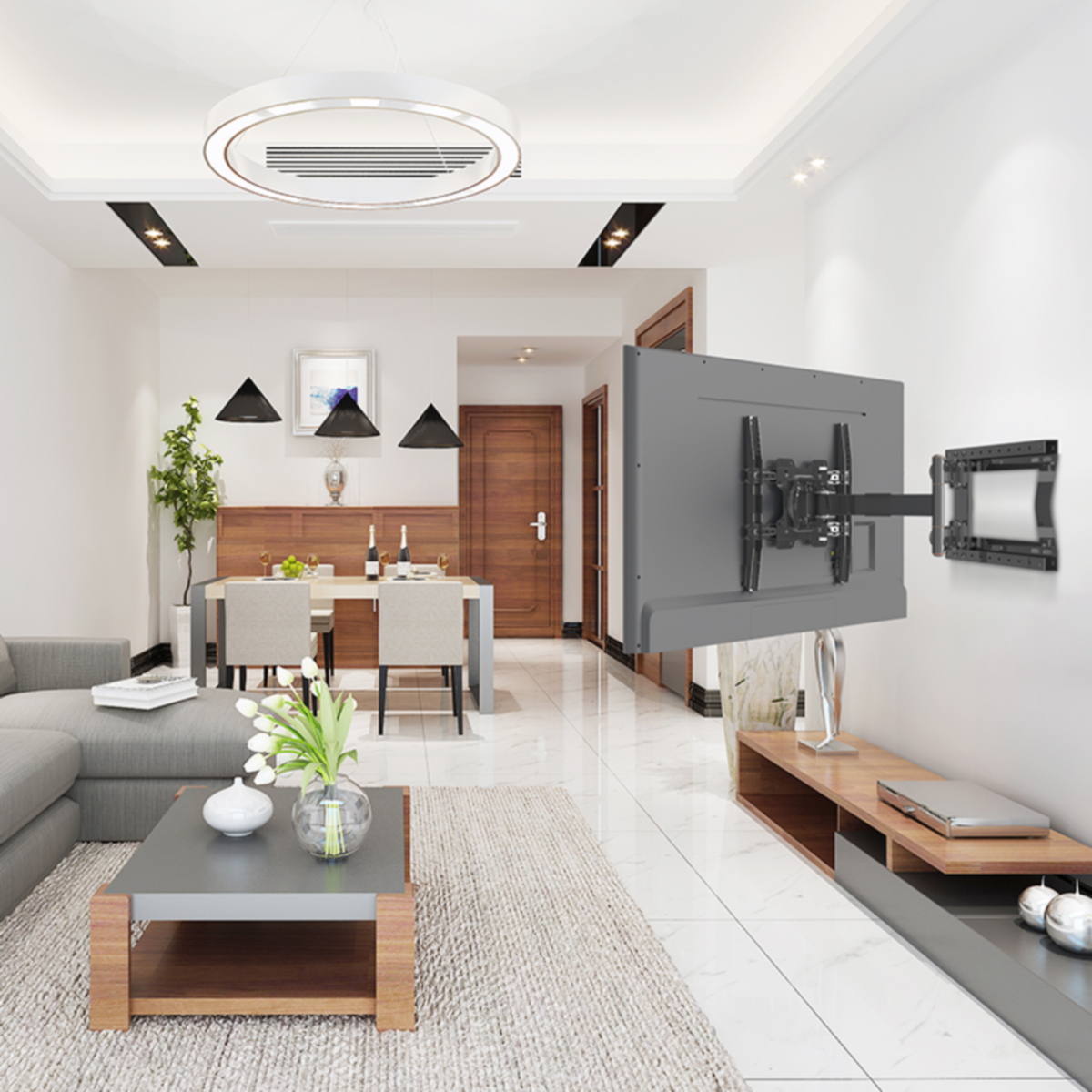 Woonkamer met een tv aan een muurbeugel, een bank en een eethoek. Witte muren.