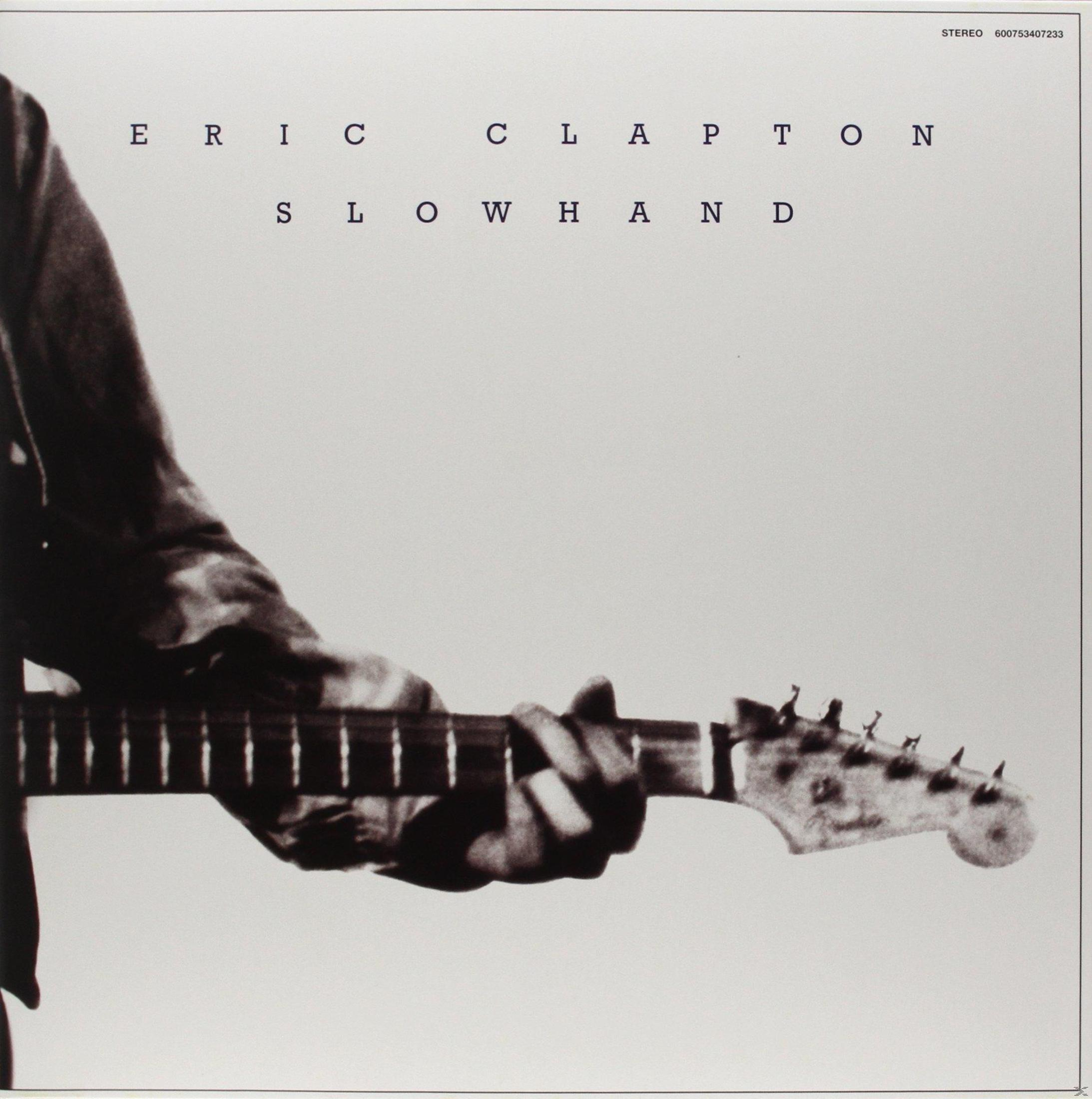 Pochette d'album avec Eric Clapton, tenant une guitare, sur un fond blanc.