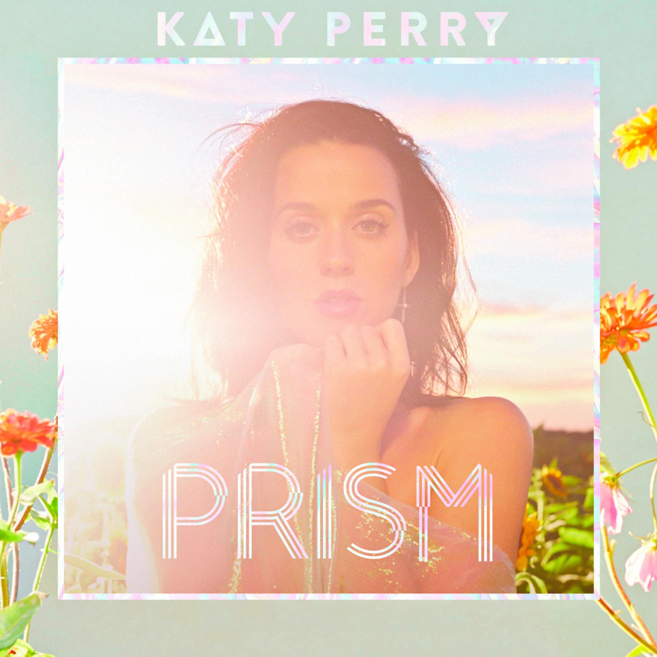 La pochette de l'album 'Prism' de Katy Perry présente son visage centré avec un effet prisme et des bordures florales.