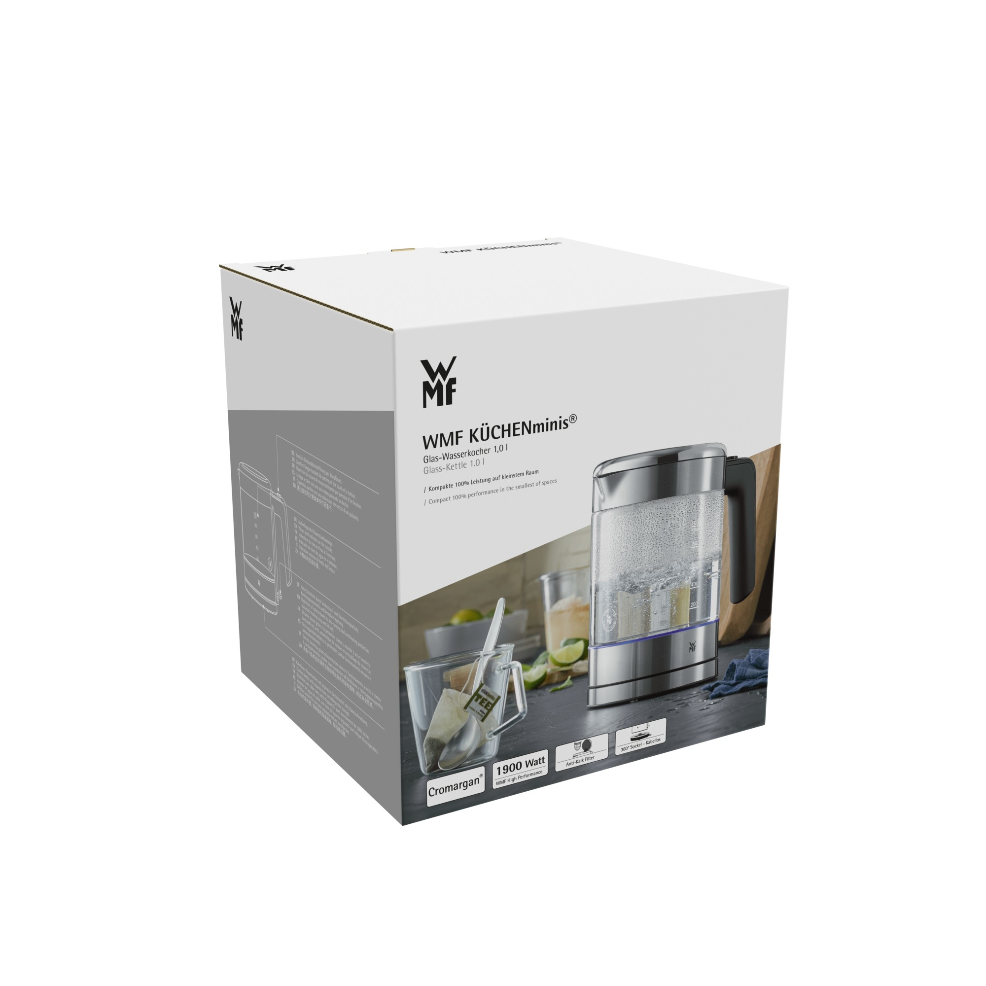 Zapakowany czajnik elektryczny WMF KÜCHENminis, pokazujący czajnik z wrzącą wodą i szklanką.