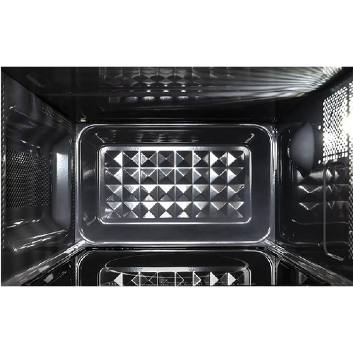 Interior de un horno de microondas, que muestra una base con patrón cuadrado y paredes oscuras. Superficies reflectantes.