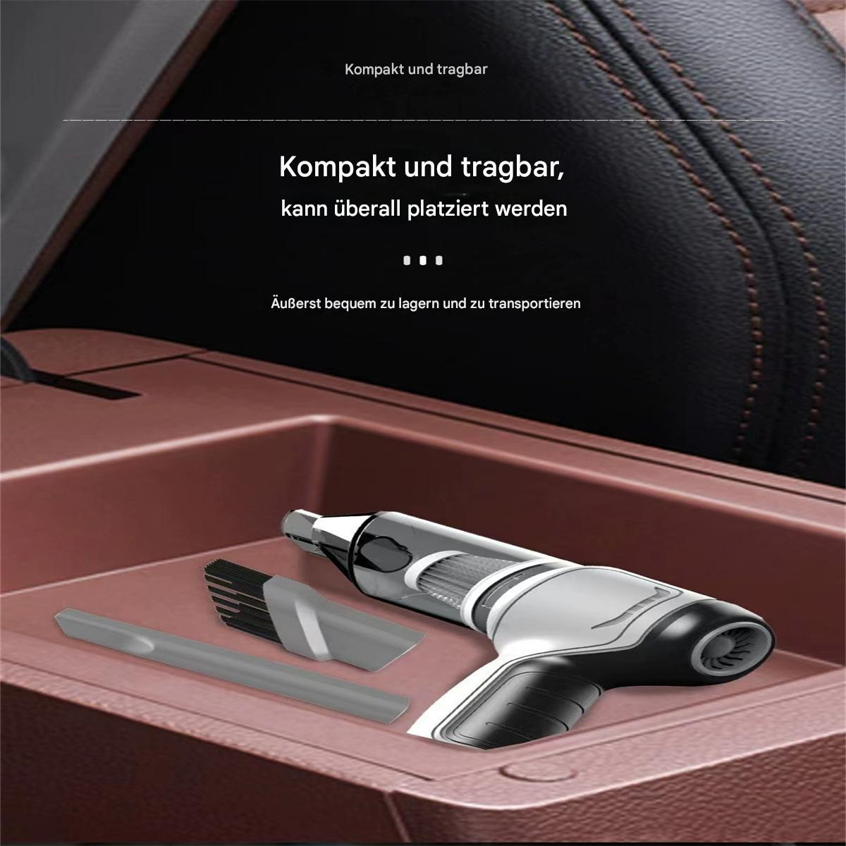 Ein Mini-Handstaubsauger mit Aufsätzen auf einer braunen Oberfläche.