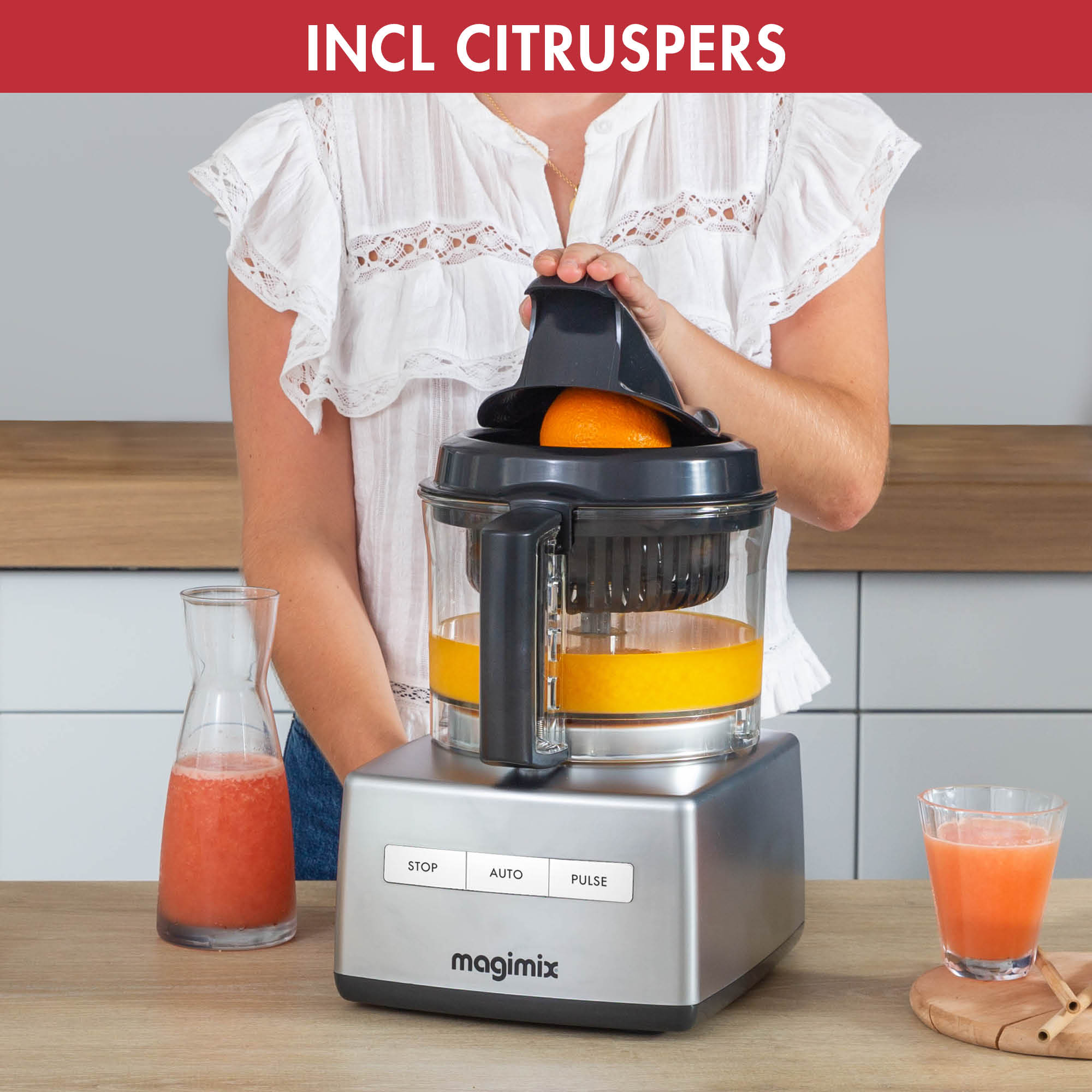 A person using a food processor to juice an orange, with juice and pulp visible.