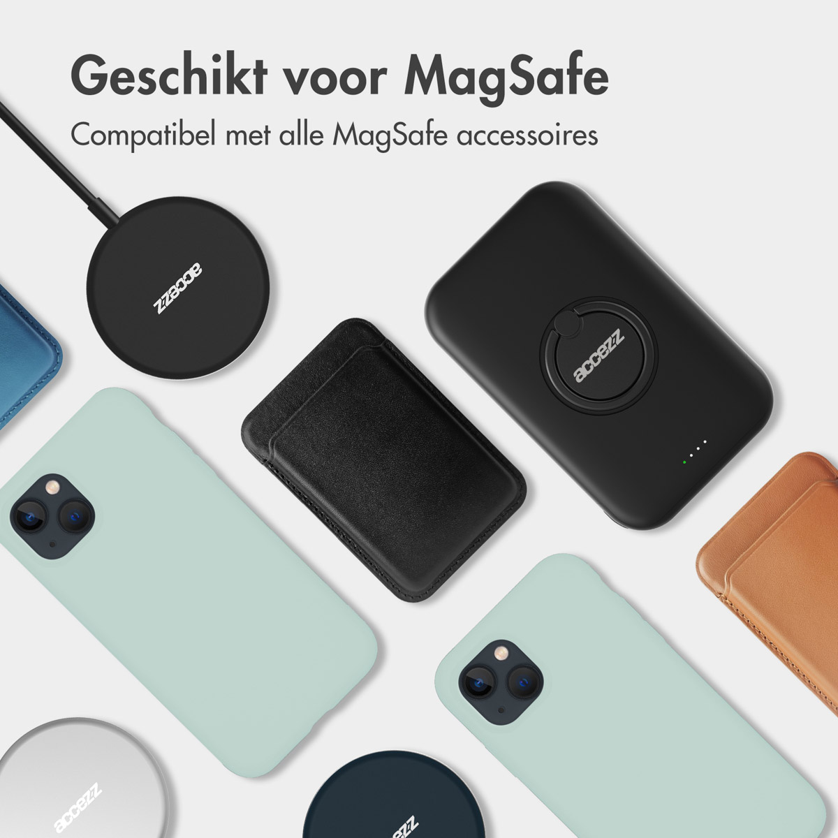 Verschillende telefoonaccessoires op een oppervlak: hoesjes, een oplader en een ringhouder.