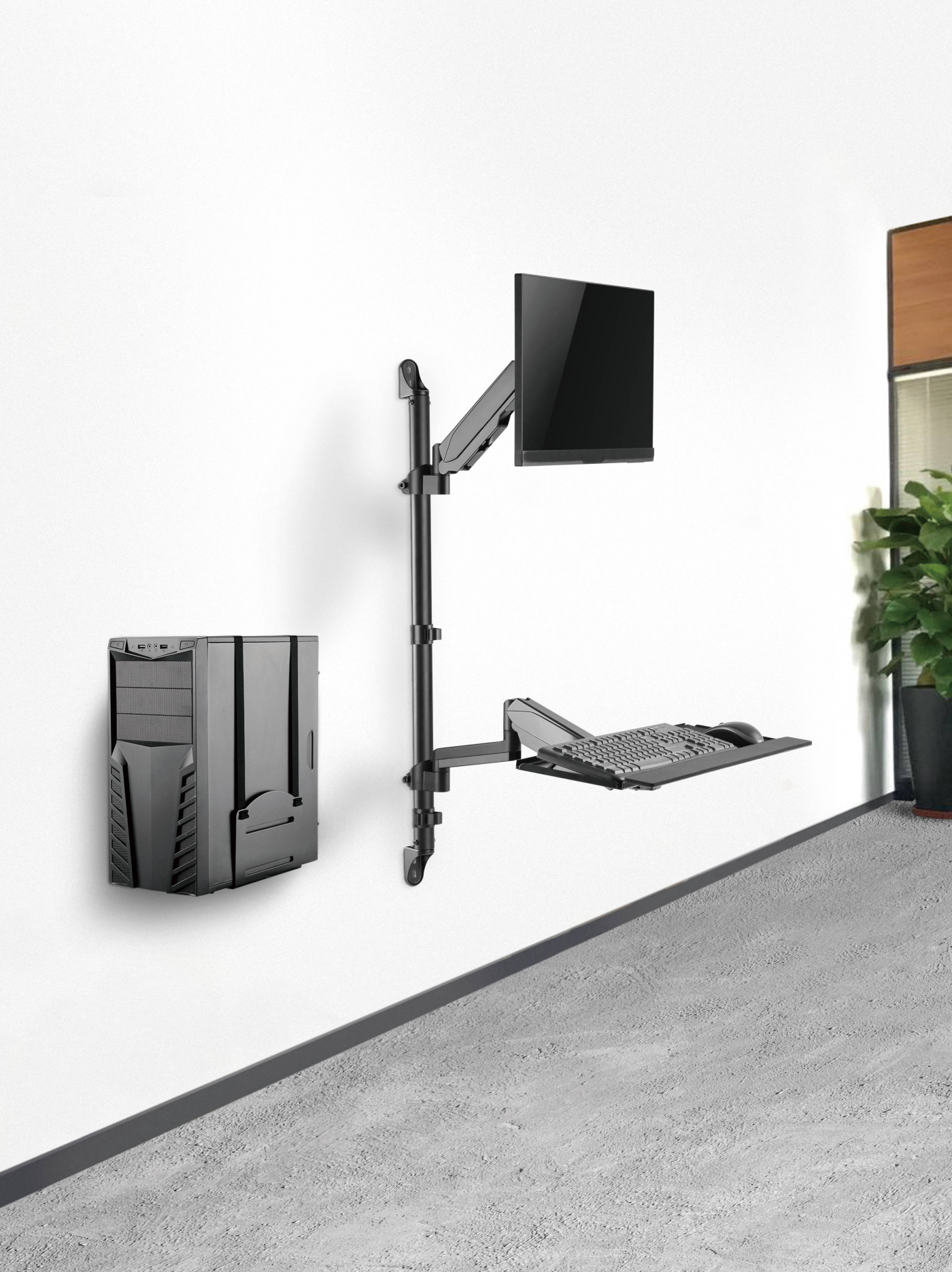 Een aan de muur gemonteerde computeropstelling: CPU, monitor, toetsenbord en muis, allemaal zwart.