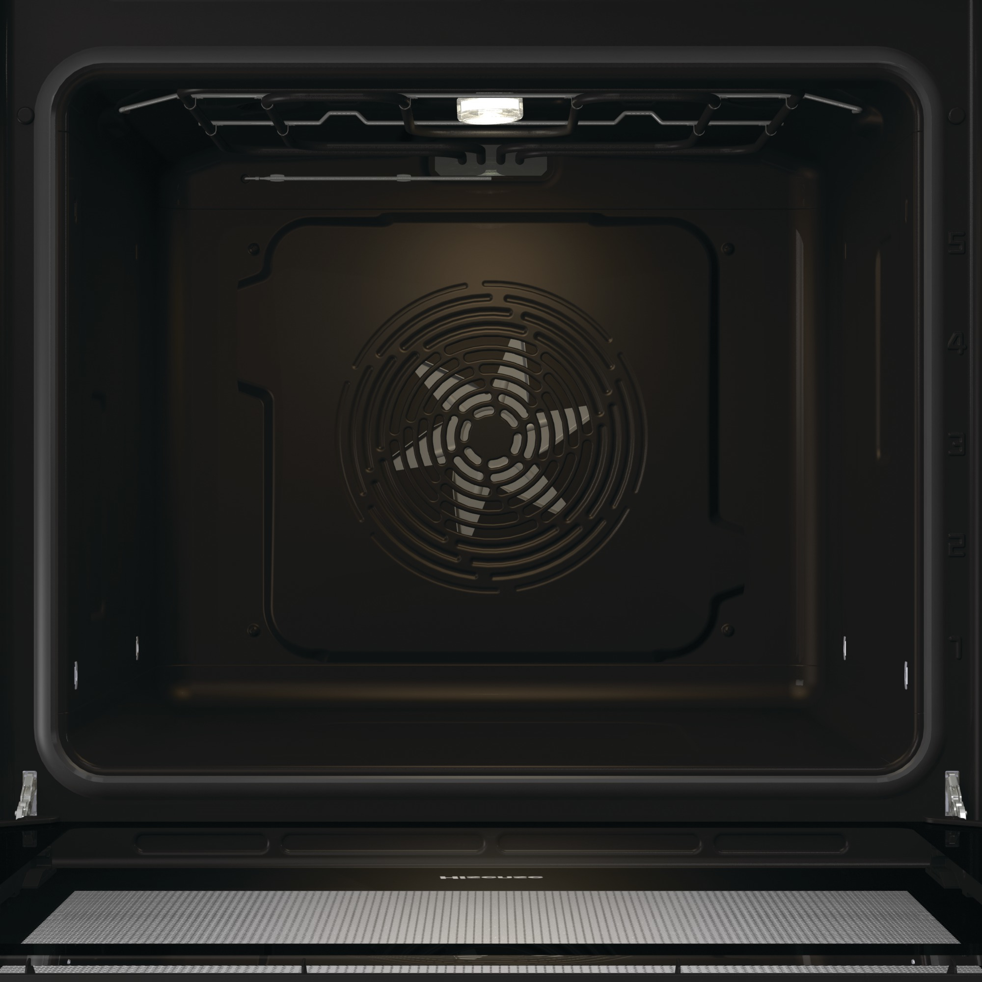 All'interno di un forno scuro. Una ventola al centro con un design a stella. Una piccola luce in alto.