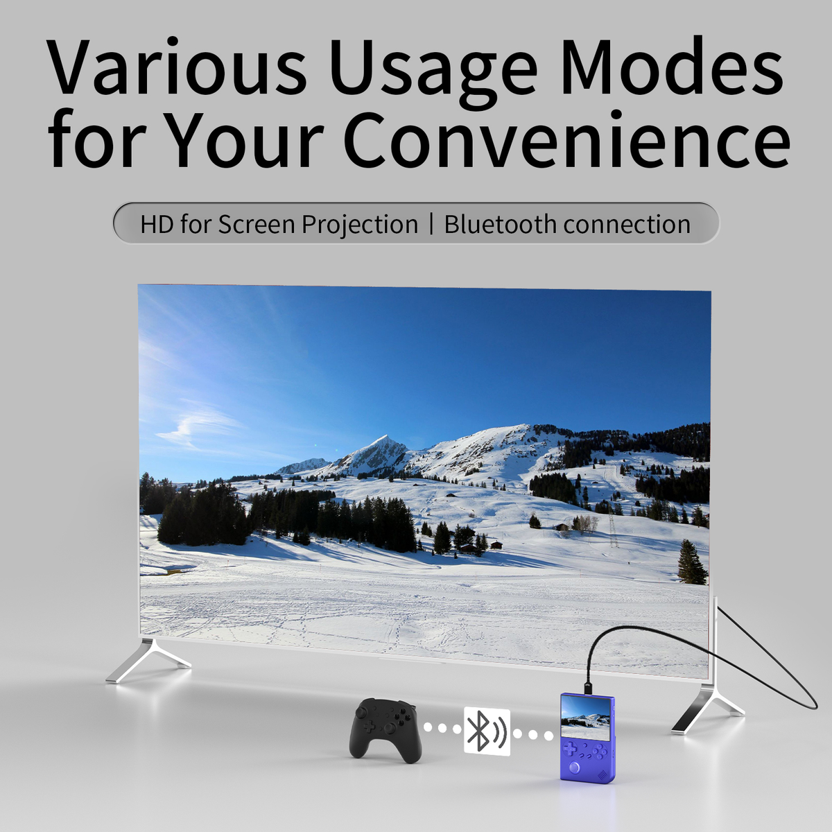 Un televisore mostra una scena di montagna innevata. Un controller wireless e un dispositivo viola collegati.