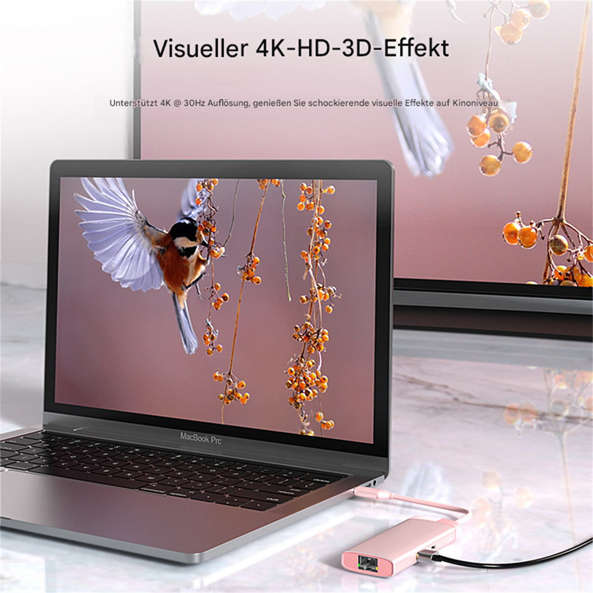 Ein Laptop, der ein Bild anzeigt, das mit einem rosa Adapter und einem Fernsehbildschirm verbunden ist.
