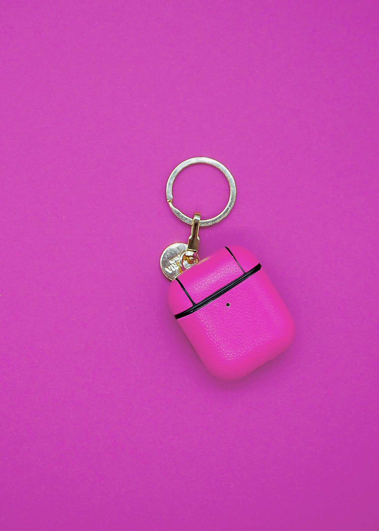 Ein pinkfarbenes Airpod-Etui mit Schlüsselring.