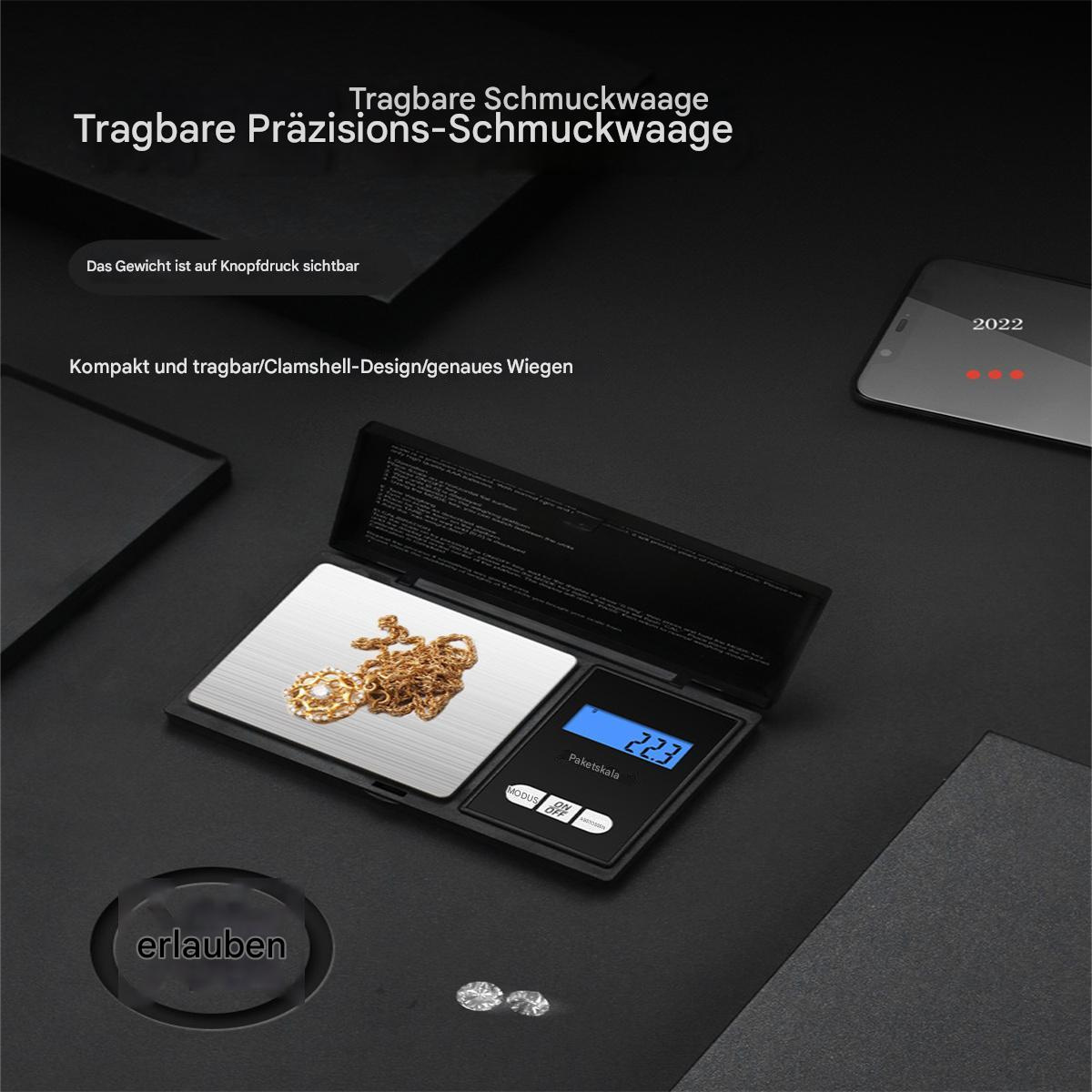 Kleine digitale Schmuckwaage mit Goldschmuck und Telefon auf schwarzer Oberfläche.
