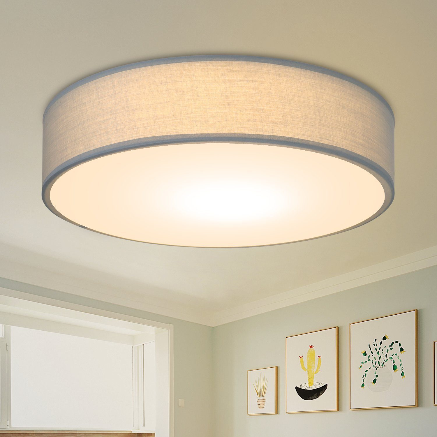 Pokazano okrągłą lampę sufitową z jasnym kloszem.