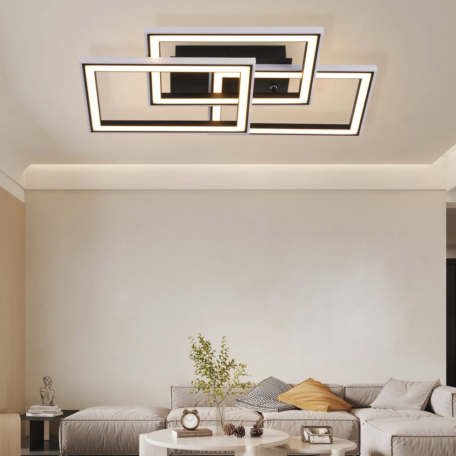 Lampa sufitowa złożona z białych i czarnych prostokątnych kształtów. Nowoczesny design w salonie.
