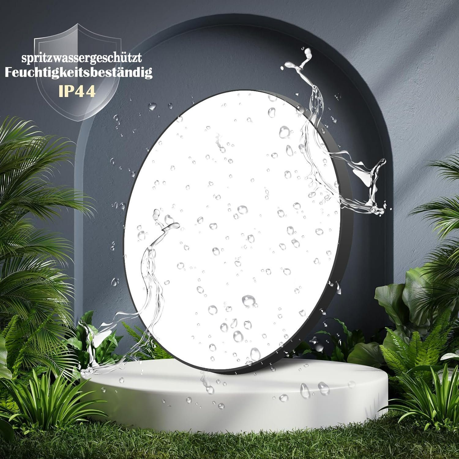 Biały, okrągły, podświetlony obiekt z rozpryskami wody, na białej platformie, z zielonymi roślinami.