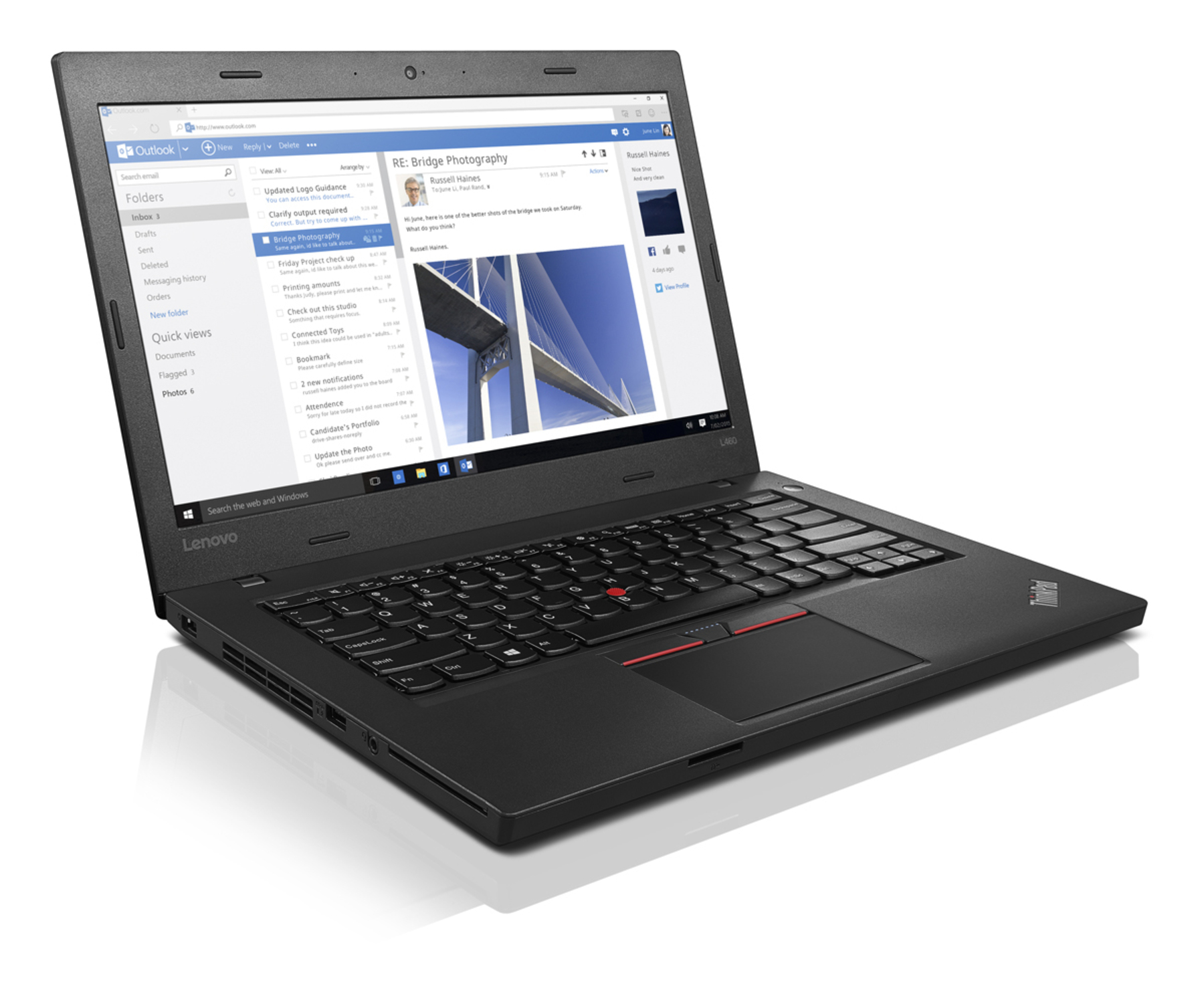 Ein schwarzes Lenovo-Laptop, das eine E-Mail mit einem Brückenfoto anzeigt.