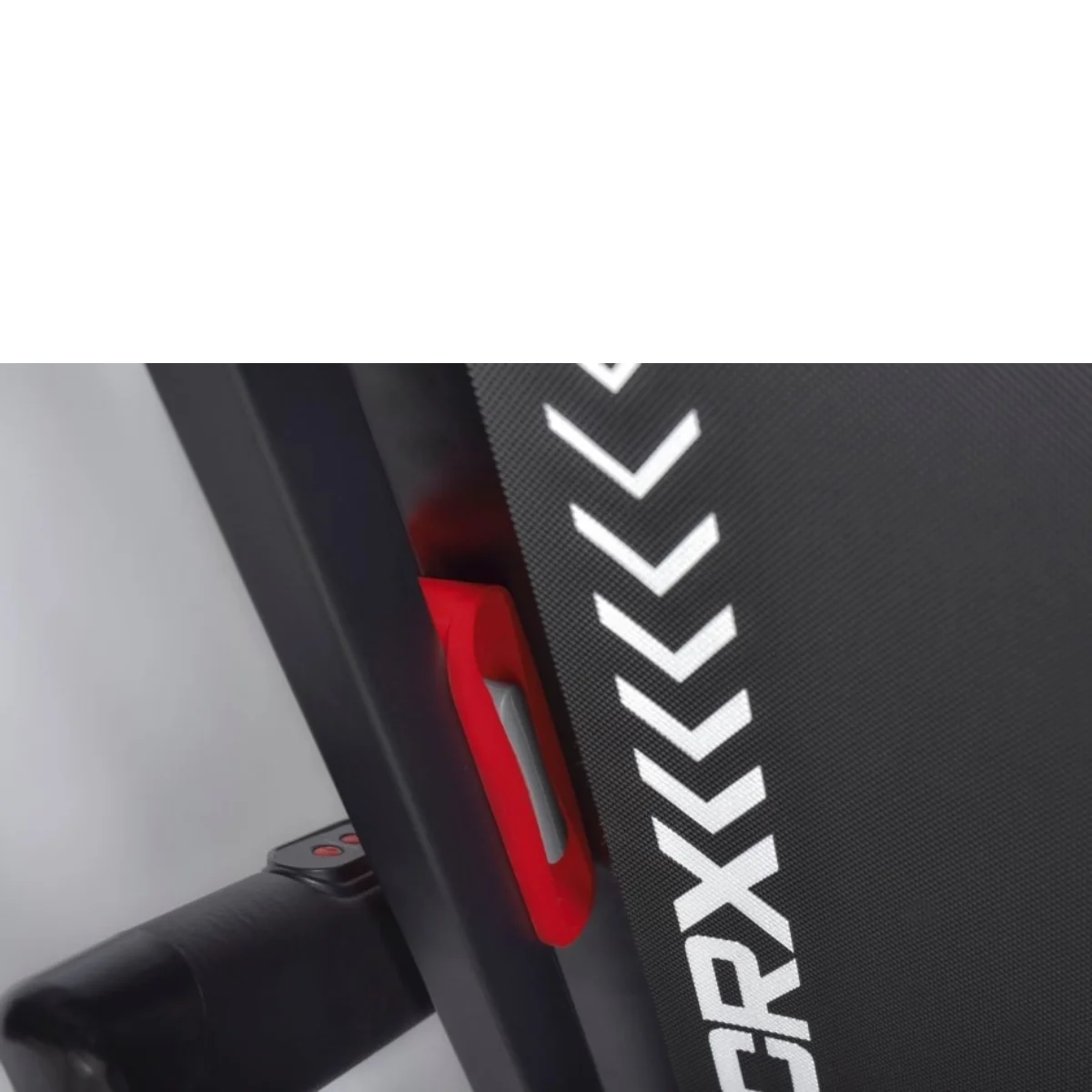 Close up of a treadmill's console and a red safety key in place. The machine is black and white.