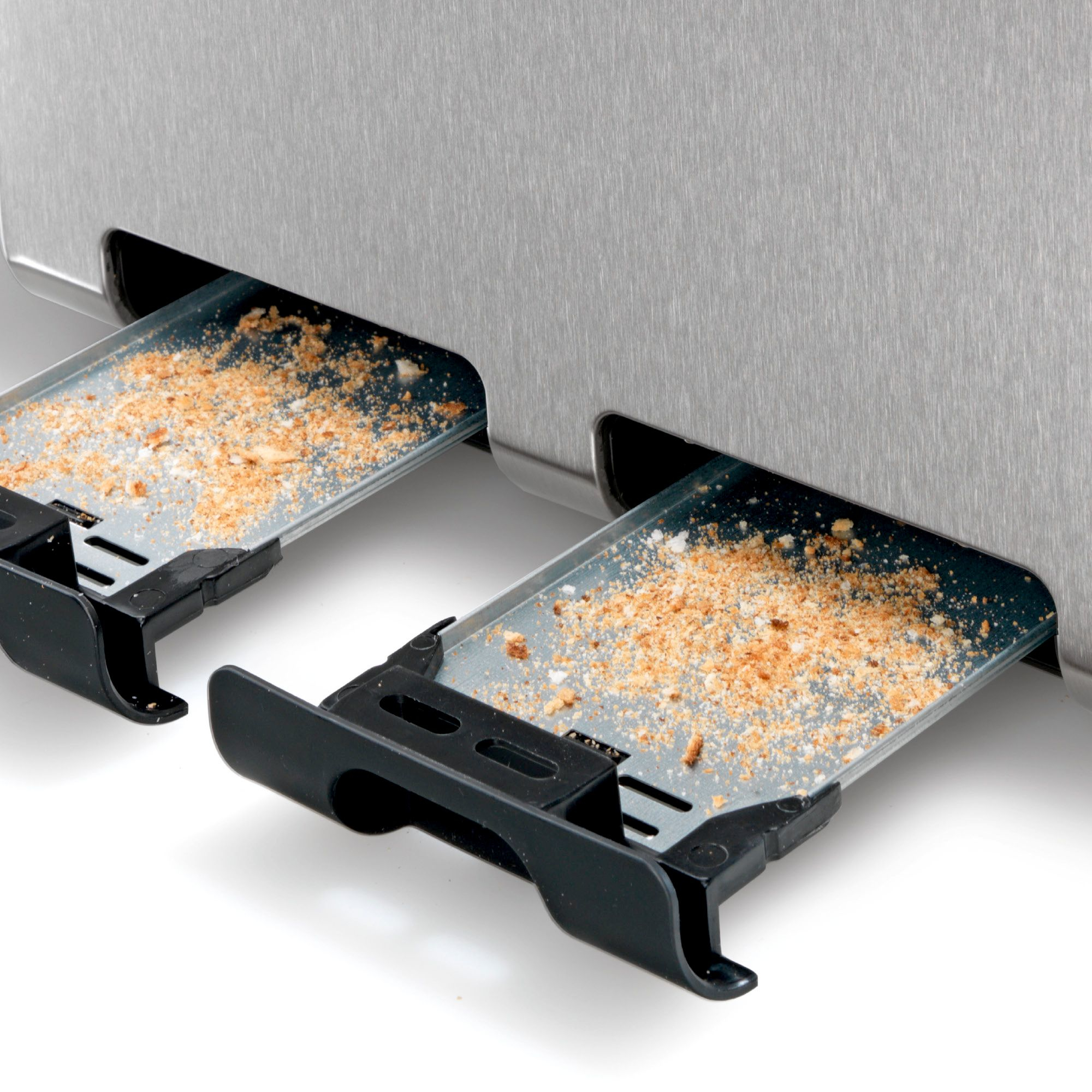 Krümelschubladen des Toasters. Zwei Schubladen mit Brotkrumen gefüllt.