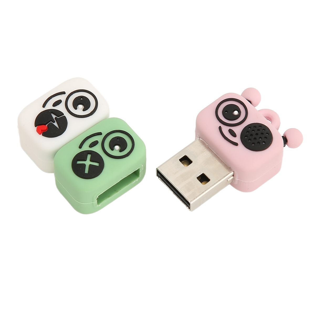 Drei USB-Sticks mit Cartoon-Charakter-Designs. Weiß, grün und rosa. Weißer Hintergrund.