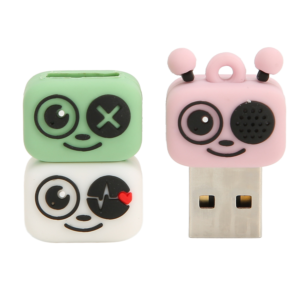 USB-Sticks, zwei sind wie Cartoon-Gesichter geformt. Einer ist grün mit X-Augen, der andere rosa mit einem zwinkernden Auge.