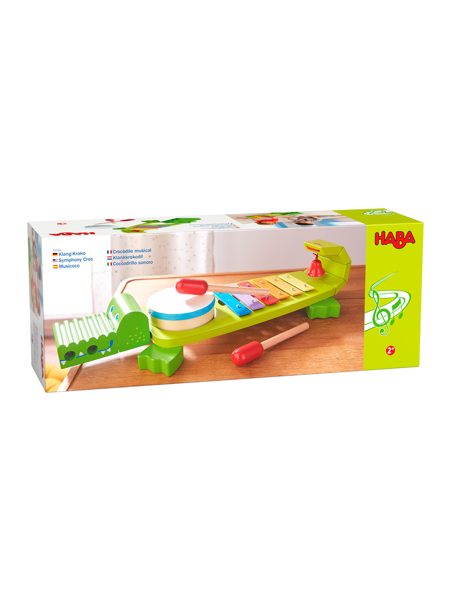 Grünes Xylophon-Spielzeug in Krokodilform, bunte Tasten, zwei rote Schlägel und eine weiße Box.