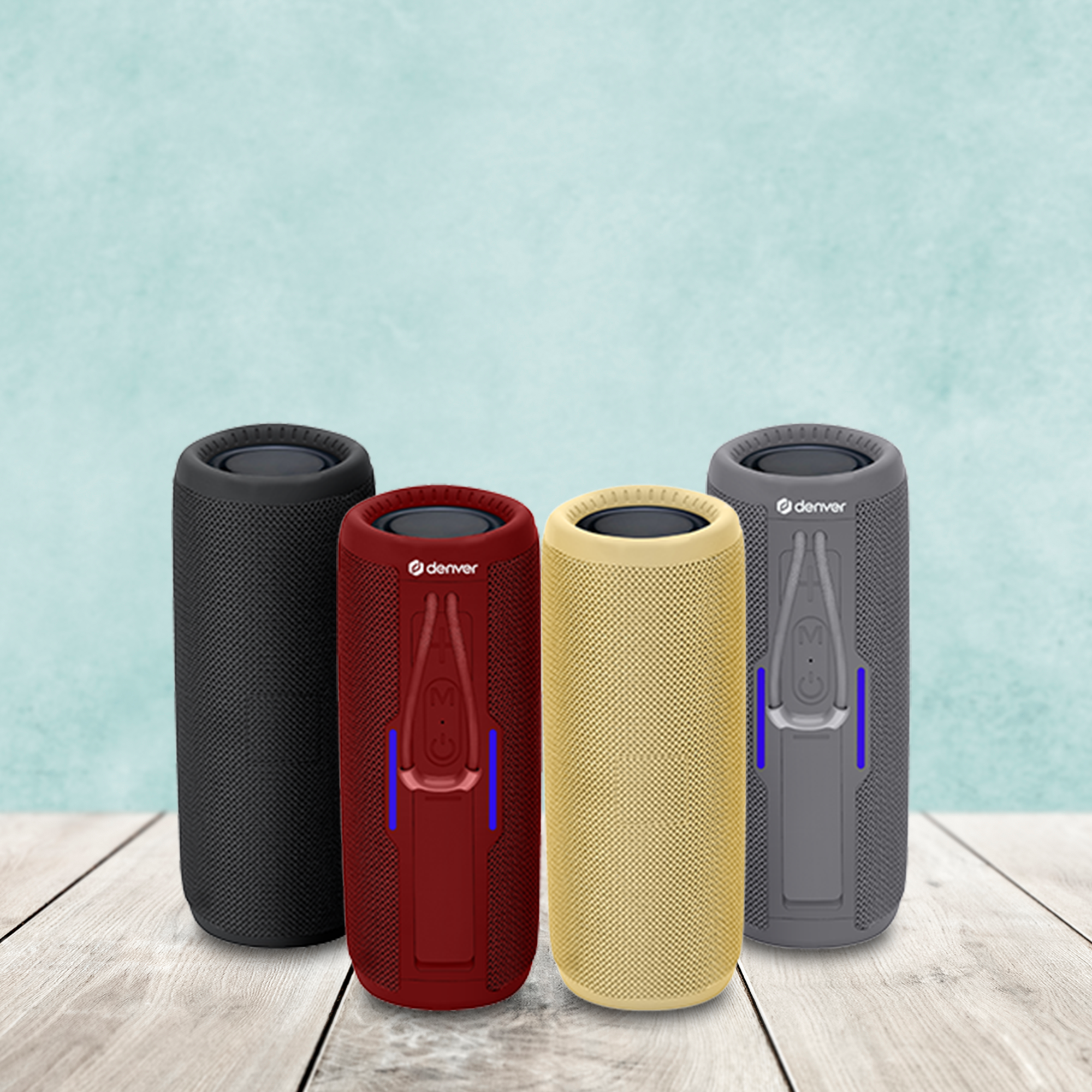 Cztery pionowe głośniki z logo Denver; czarny, czerwony, żółty i szary na drewnianej powierzchni.