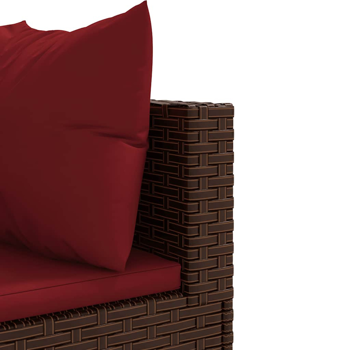 Una almohada roja descansa sobre un sofá tejido marrón con un cojín rojo.