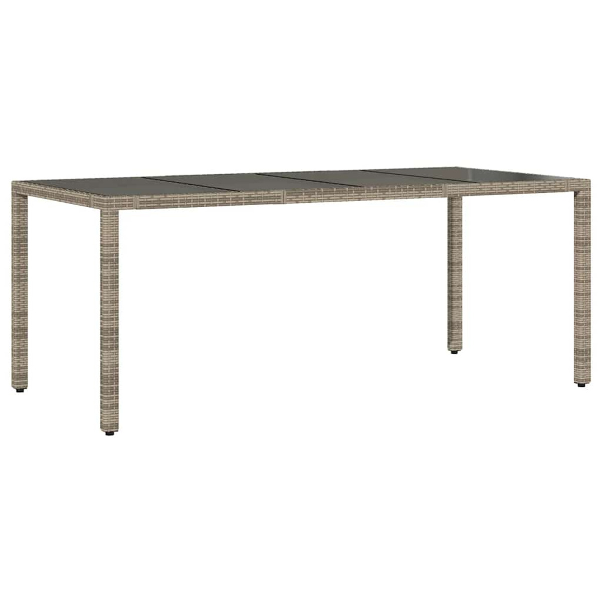 Un tavolo lungo, rettangolare, in vimini marrone chiaro con gambe nere su un patio.
