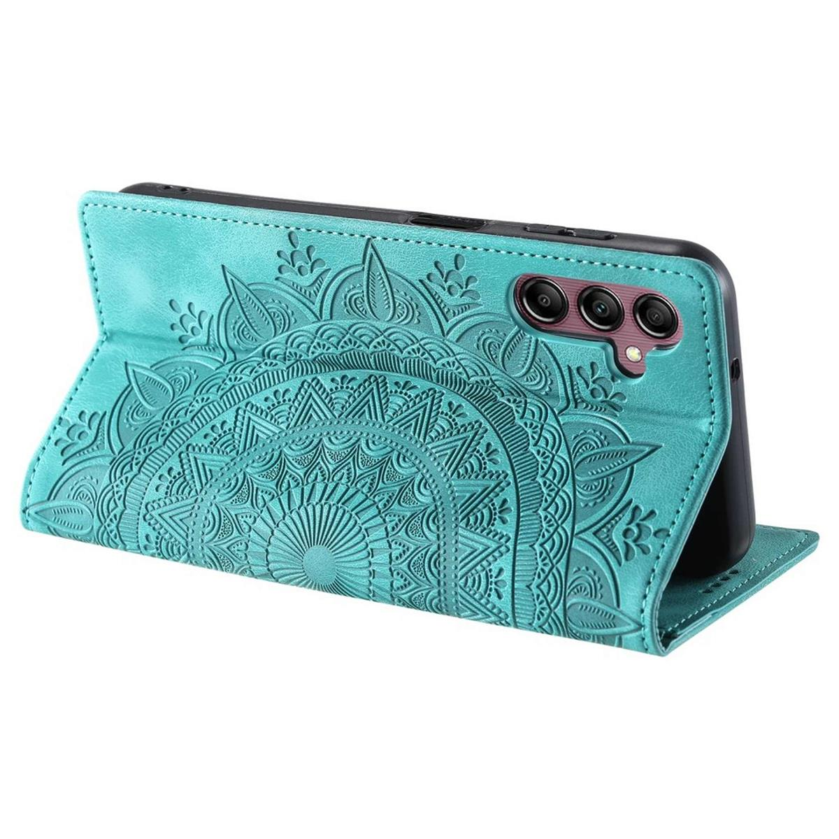 Türkisfarbene Handyhülle mit Mandala-Design, aufgeklappt zum Aufstellen. Telefon und Kamera sichtbar.