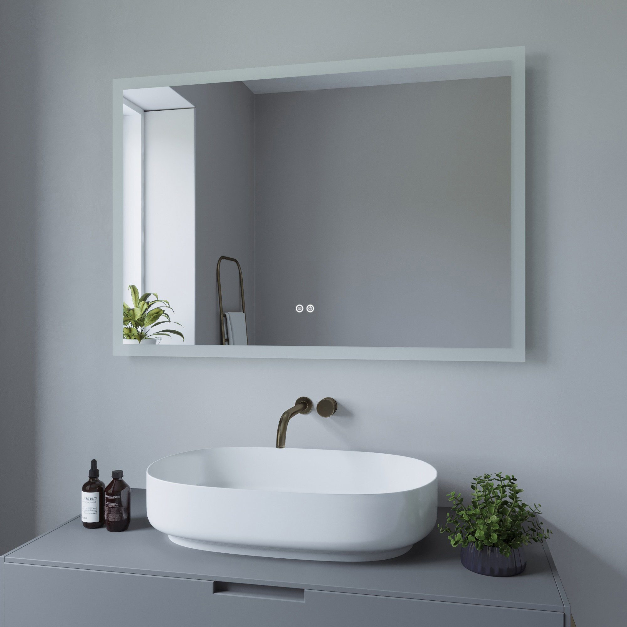Modernes Badezimmer mit großem Spiegel über einem Waschbecken und einer Pflanze.