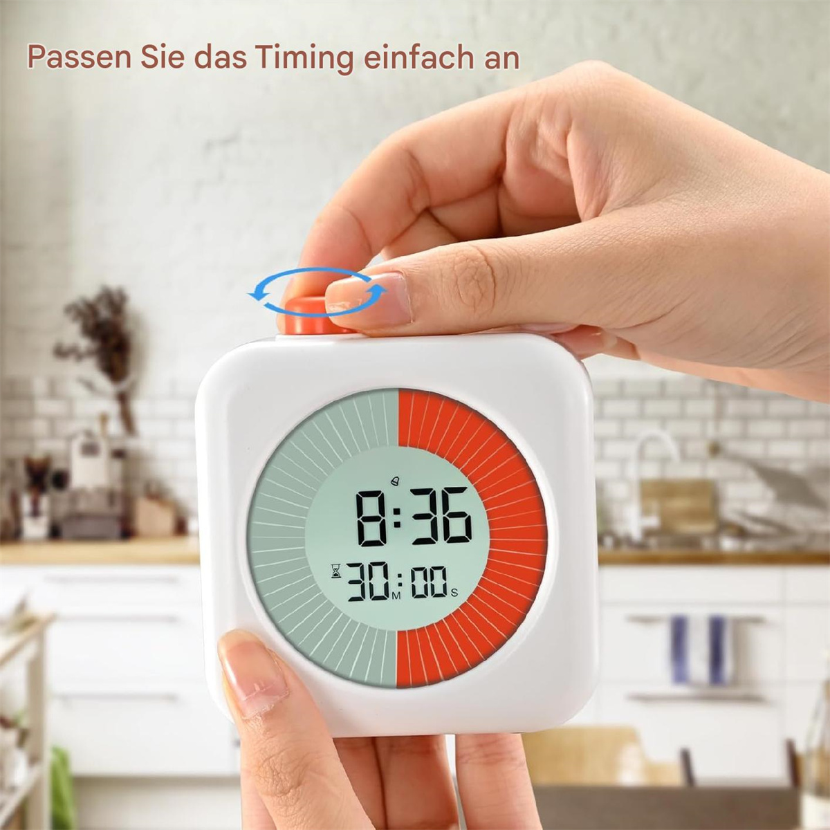 Die Hand einer Person, die einen weißen Timer mit rotem und grünem Zifferblatt einstellt, drinnen.