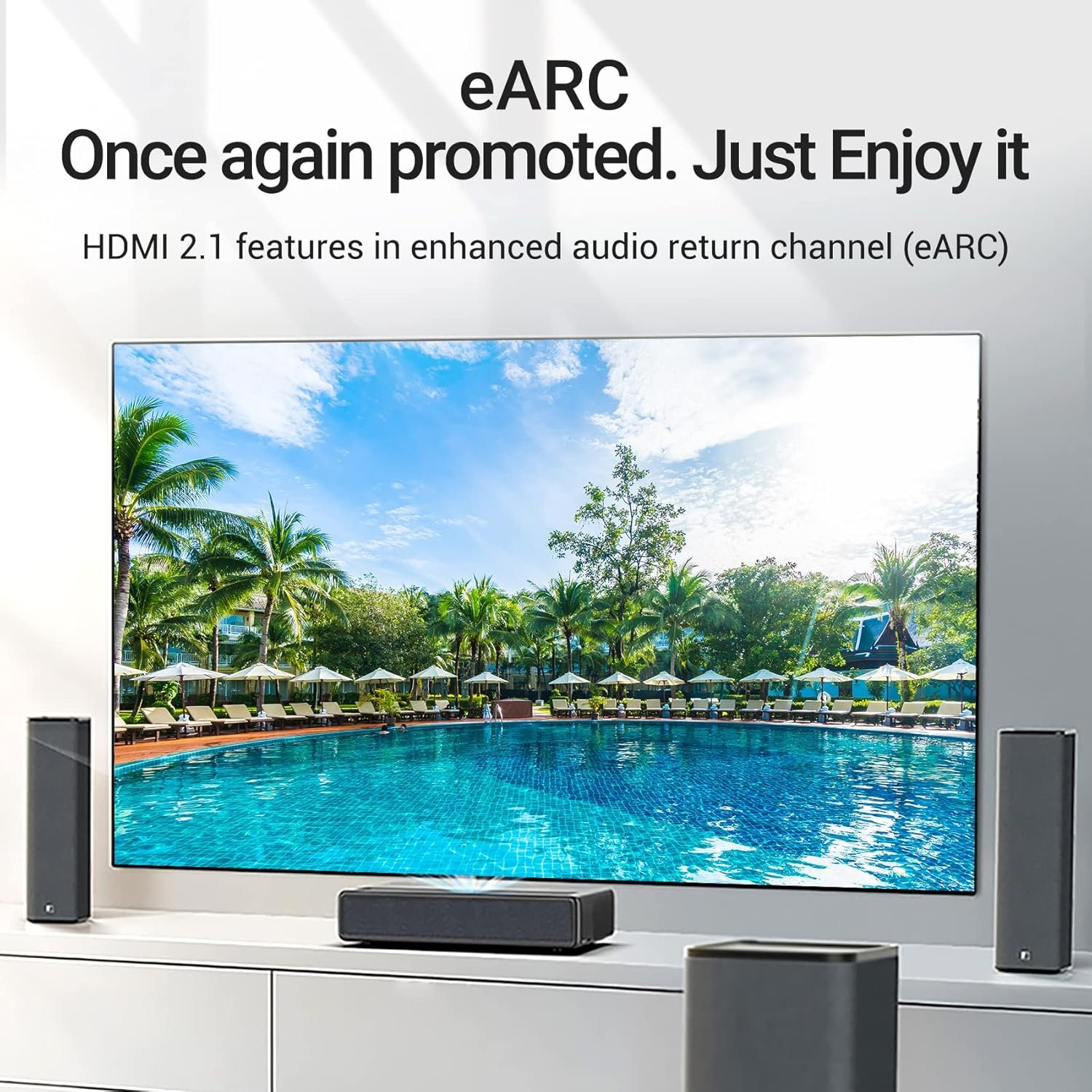 Modernes Wohnzimmer mit TV, der eine Strand-Szene zeigt. Lautsprecher und Soundbar sichtbar.