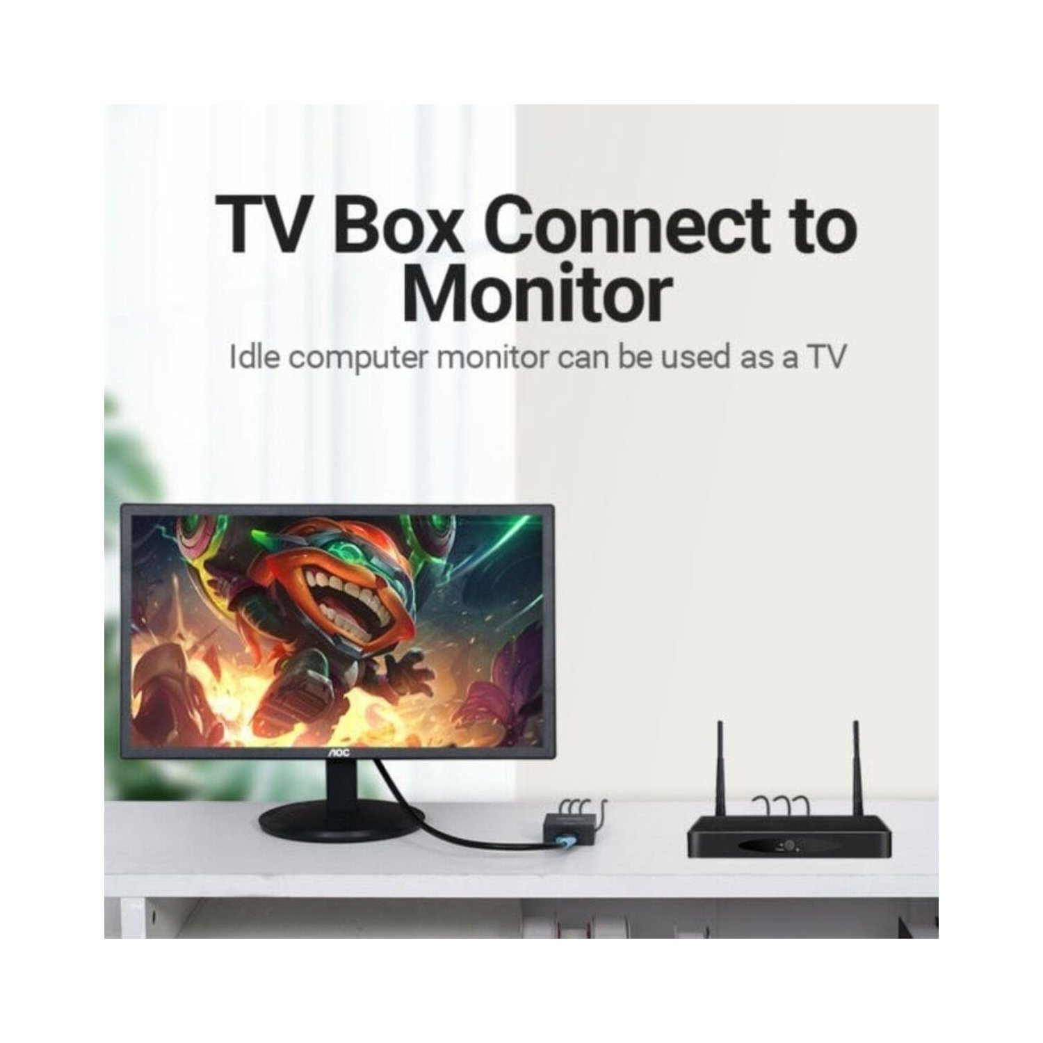 Caja de TV conectada a un monitor. Un monitor muestra una imagen de juego. Escritorio blanco.