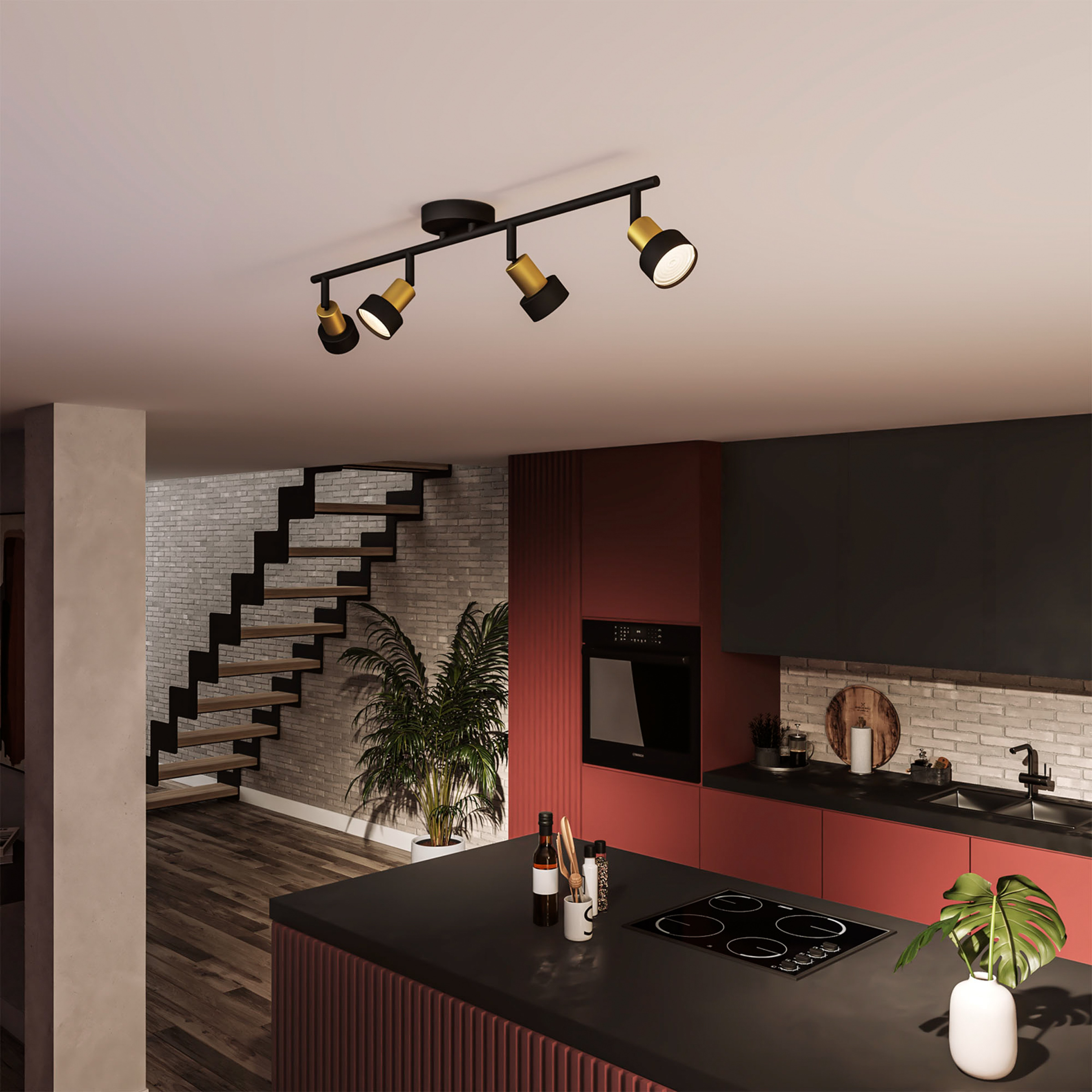 Keuken met spots aan het plafond. Een zwart eiland en een bakstenen muur zijn ook zichtbaar.