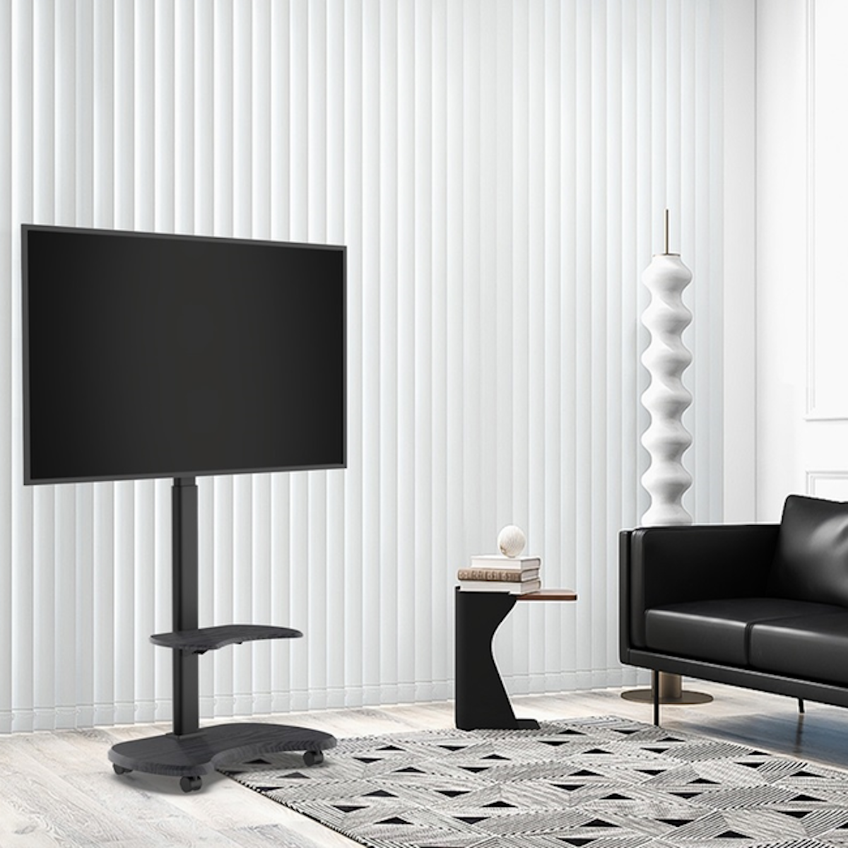 A living room with a TV on a stand, a rug, couch, and side table.