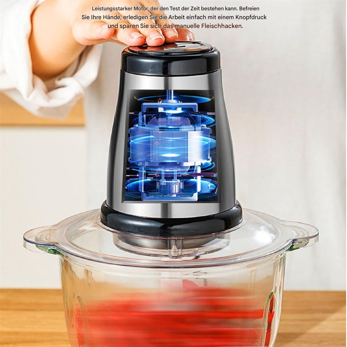 Ein transparenter Food Processor zeigt die Innenseite, er hat einen oberen schwarzen Teil.