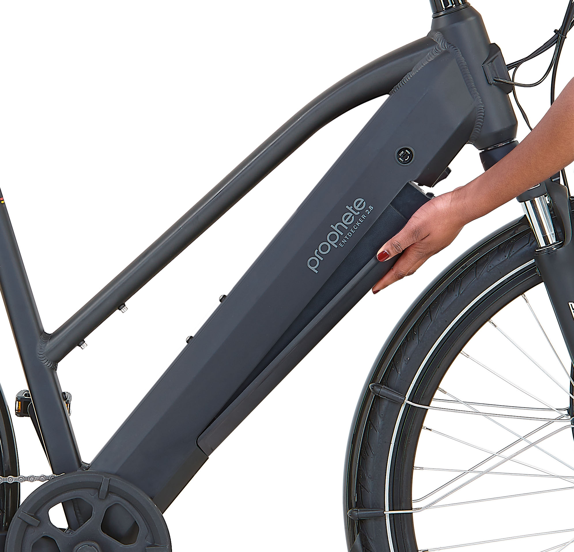 Hand entnimmt Akku aus schwarzem Elektrofahrrad.