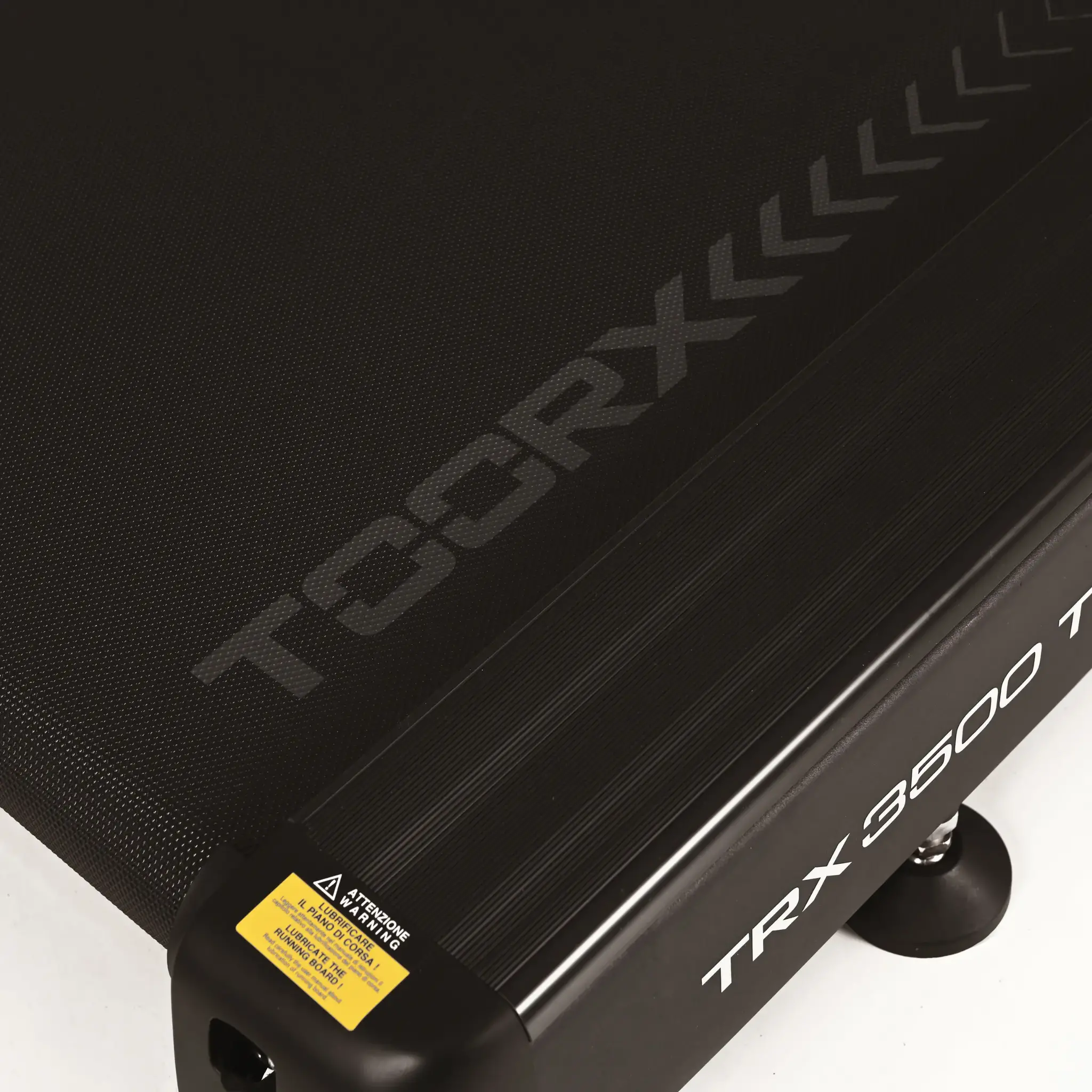 Close-up of a treadmill's running surface. Black and grey design. White background.