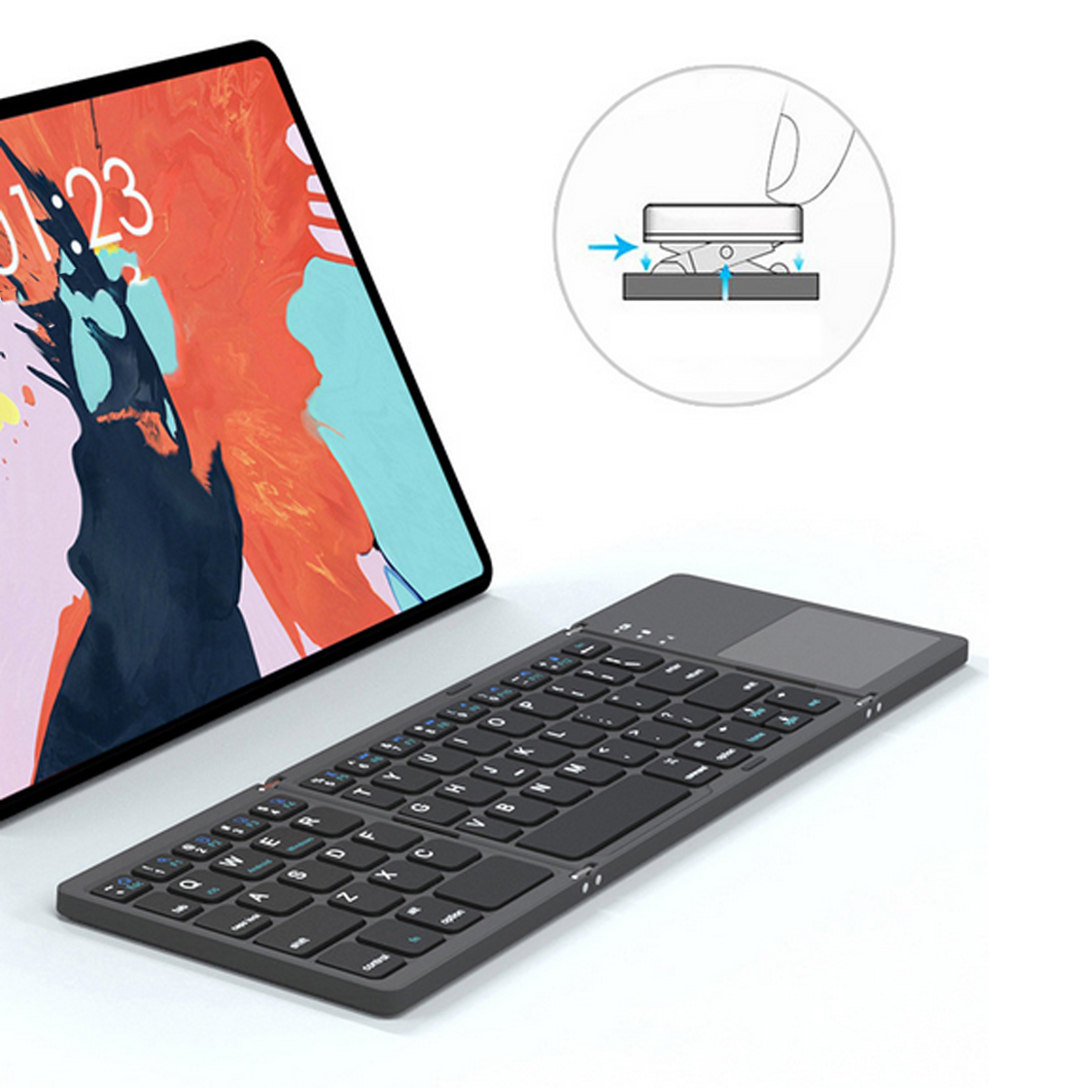 Eine schwarze Tastatur neben einem Tablet mit farbenfroher Anzeige. Ein Diagramm zeigt, wie es gefaltet wird.