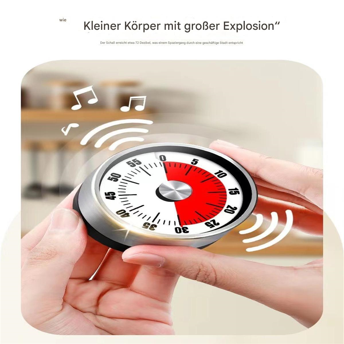 Timer mit rotem und weißem Ziffernblatt, zeigt die Zeit an. Der Timer steht auf einem Tisch.