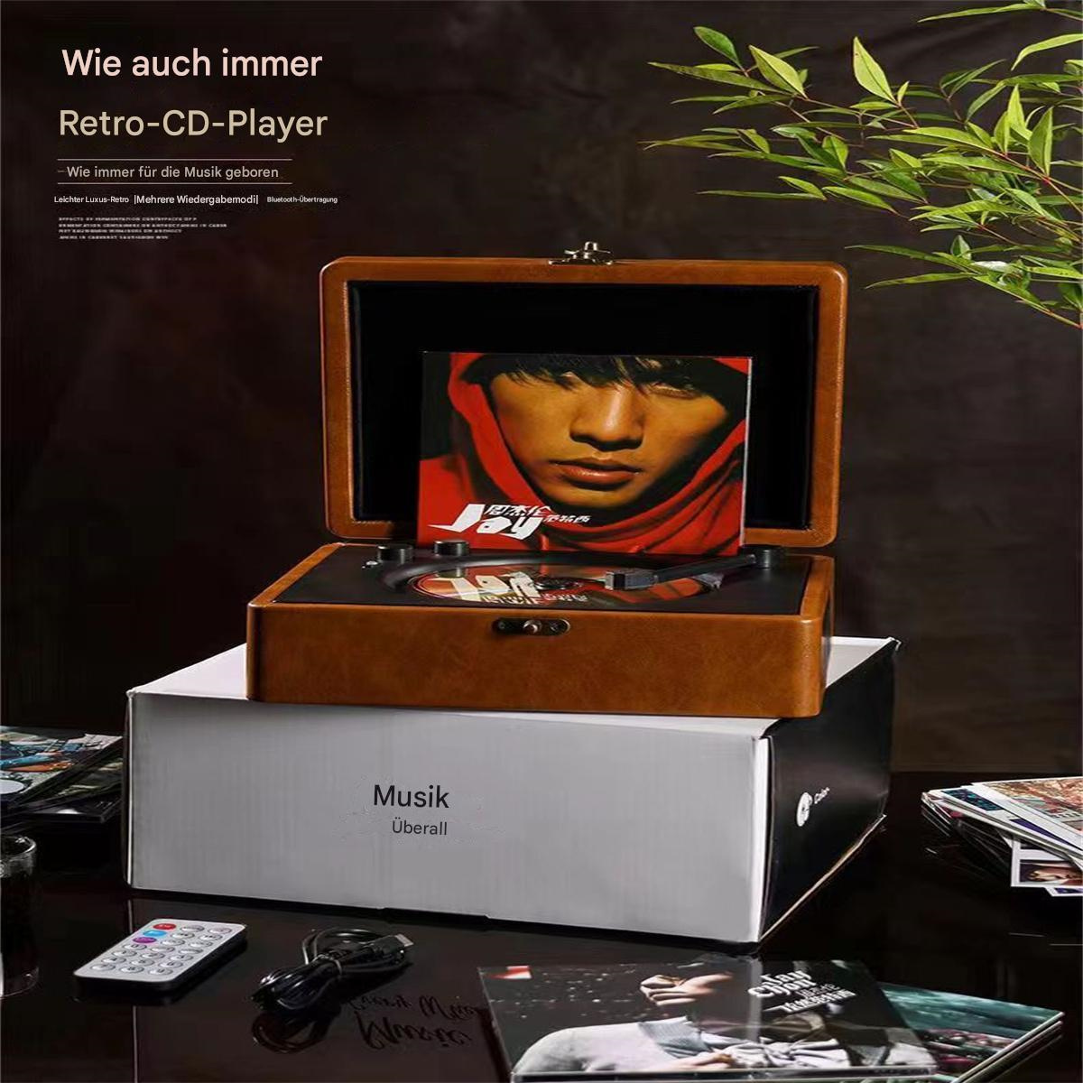 Ein Retro-CD-Player auf einer Box mit dem Wort Musik. CD-Cover ist sichtbar.