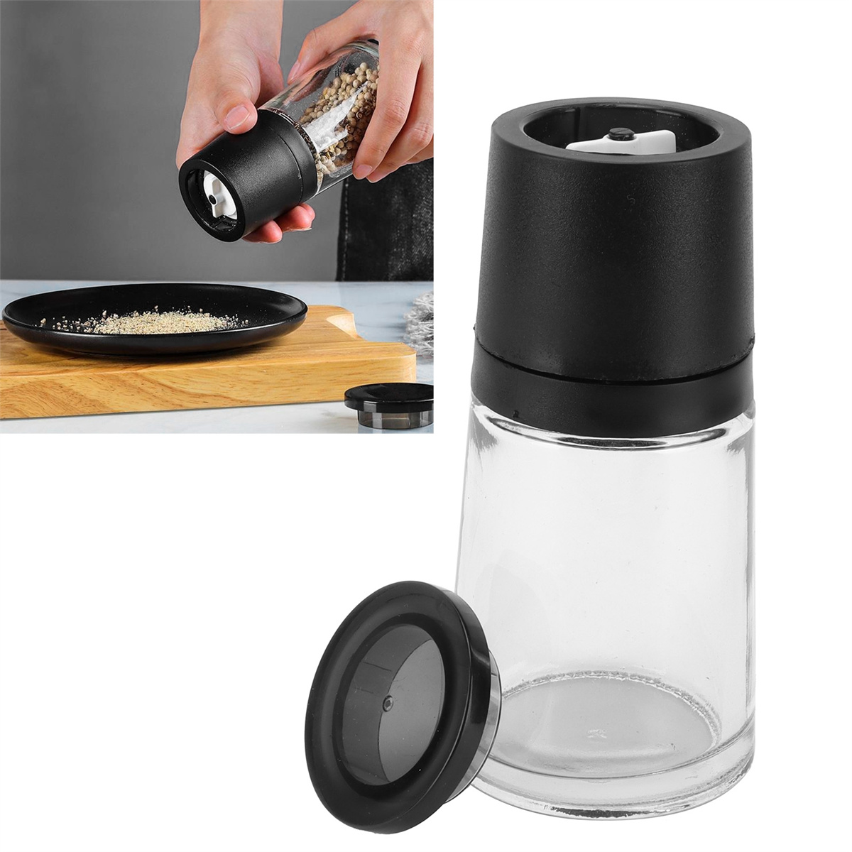 Pfeffermühle mit transparentem Glaskörper und schwarzem Deckel, mit Pfeffer auf einem Teller.