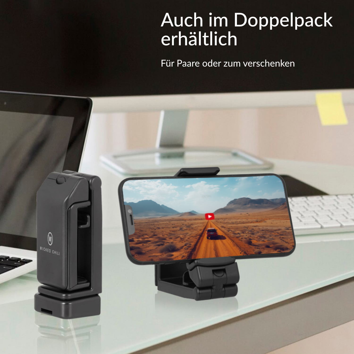 Telefon auf einem Halter mit einem Video. Links ein schwarzer Ständer.
