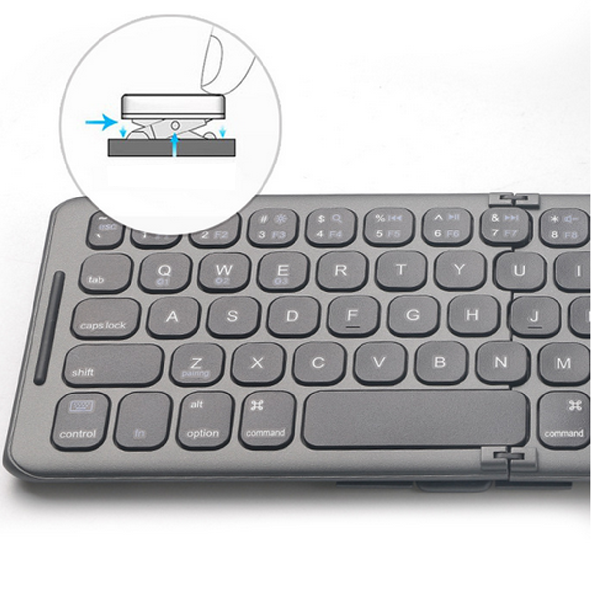 Graue Tastatur mit Nahaufnahme des Tastenmechanismus. Ein Diagramm zeigt, wie eine Taste funktioniert. Weißer Hintergrund.