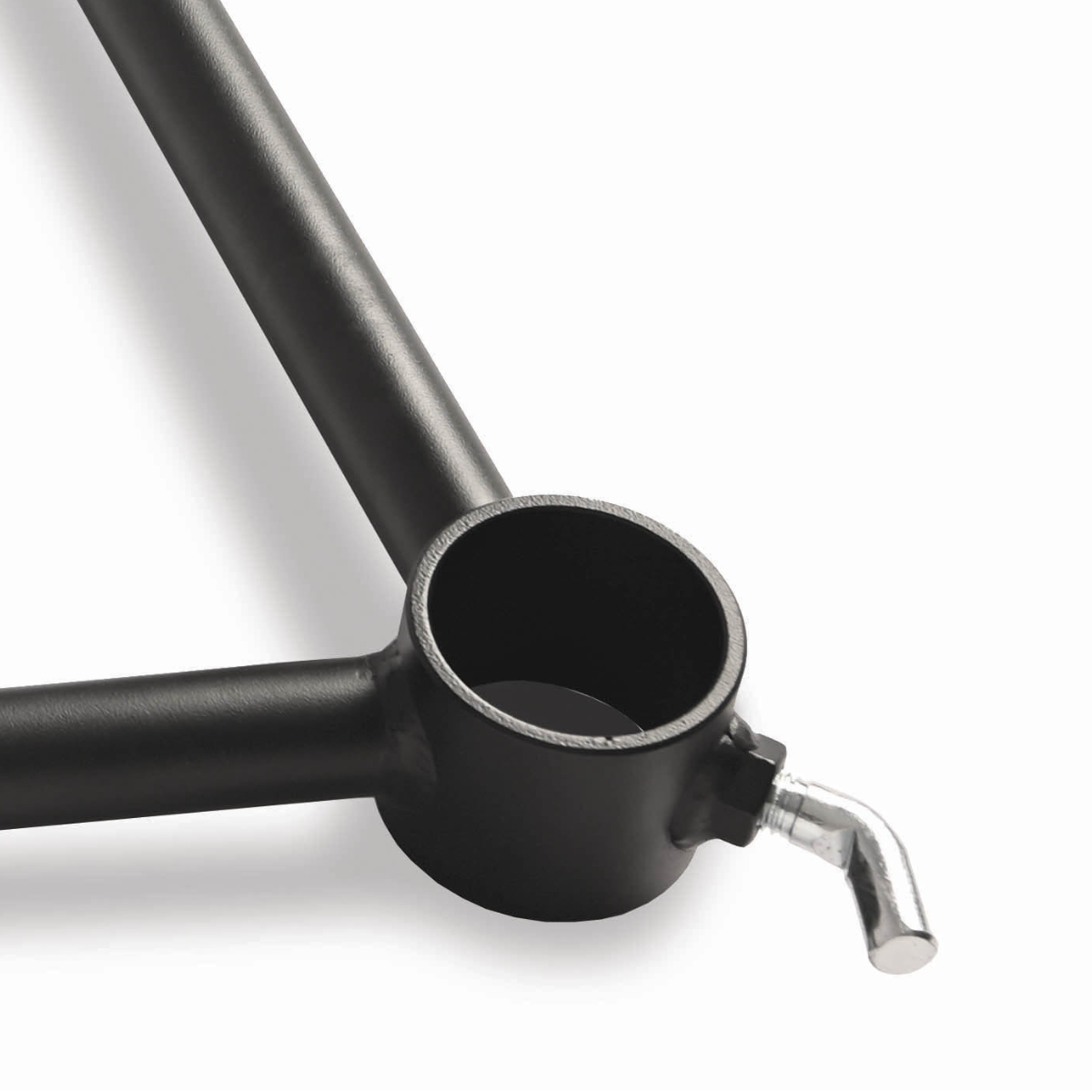 Close-up of a black metal fitting with a round hole and a silver screw-like element.