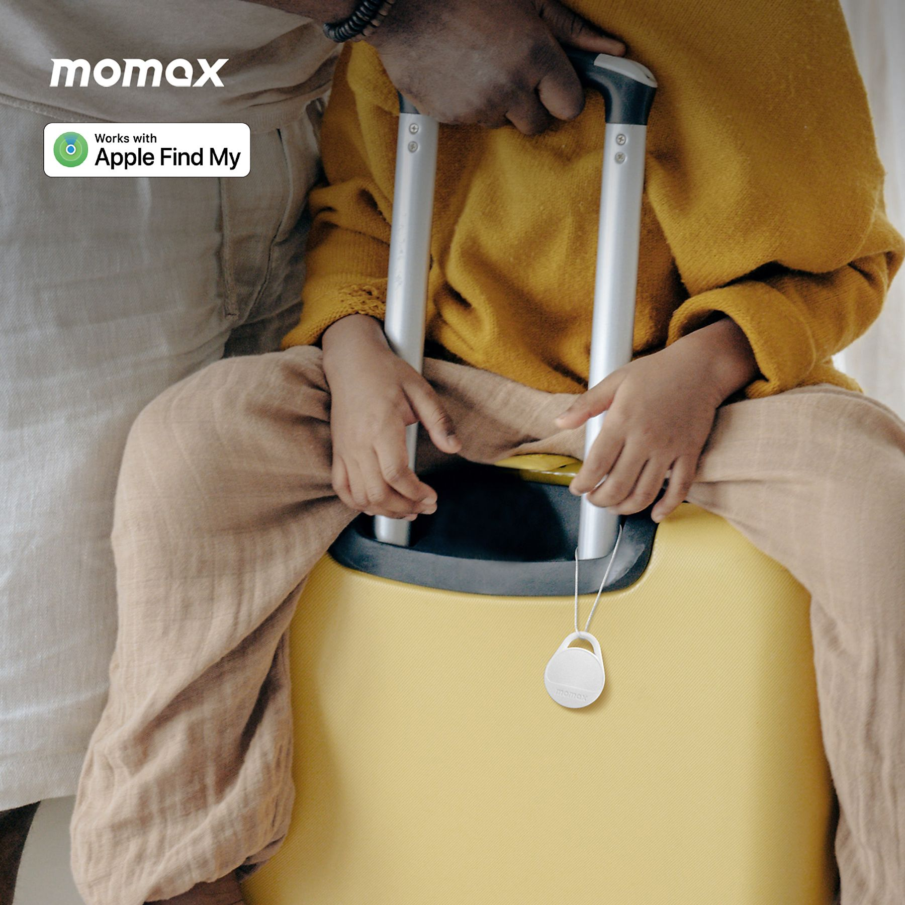Person with a yellow suitcase and a white luggage tag, near a person's hands holding the suitcase.