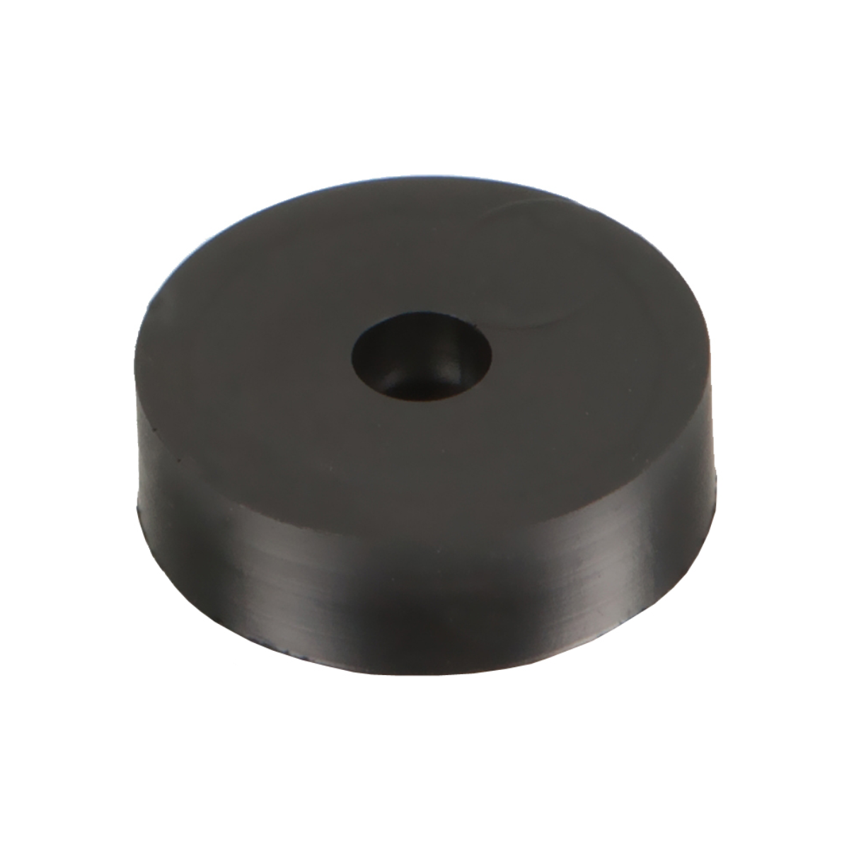 Czarny gumowy krąg z otworem pośrodku. Białe tło.